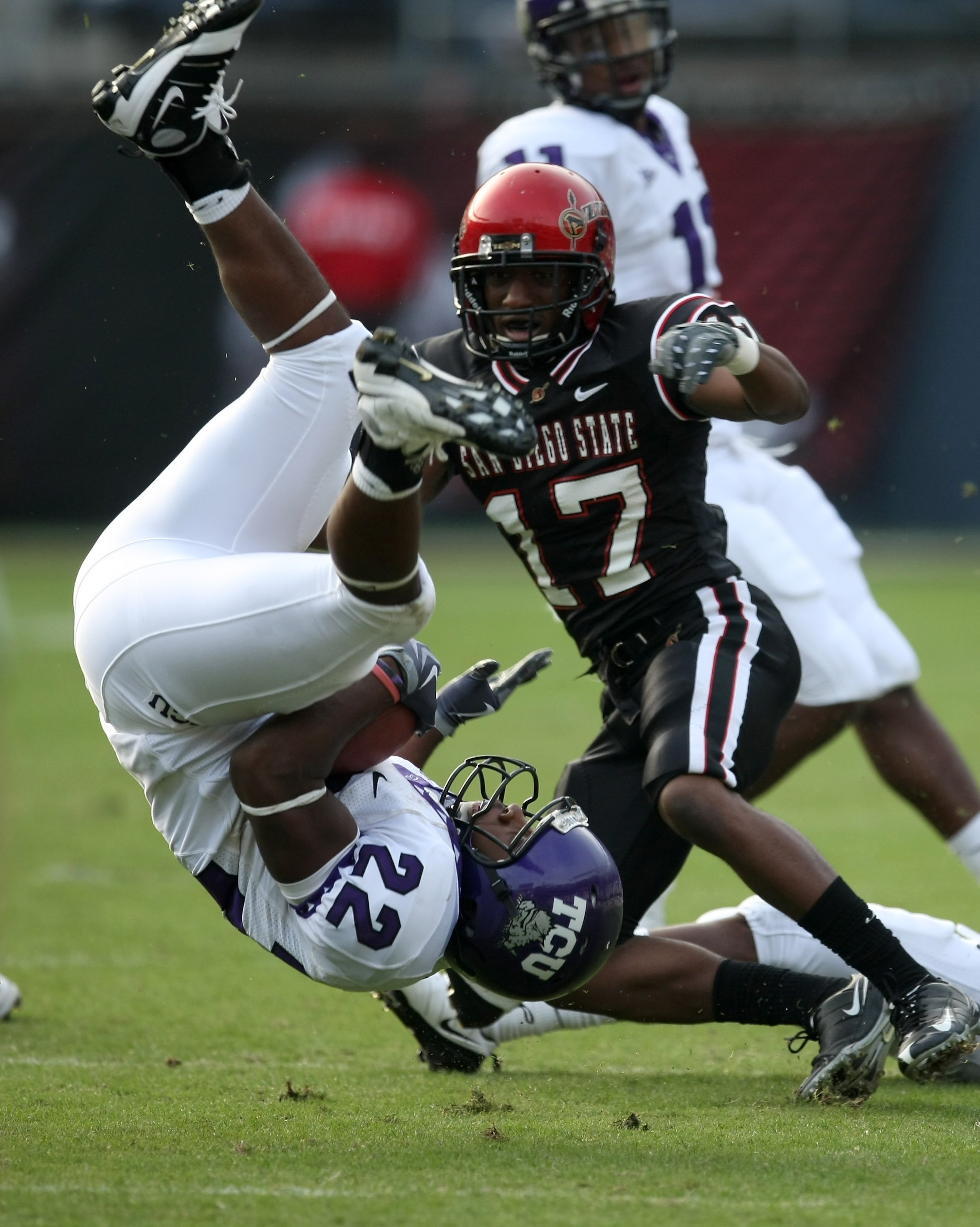 SAN DIEGO - NOVEMBER 07:  Running back Jercell Fort #22 of the Texas Christian University Horned Frogs flips as he is upended by defensive back Josh Wade #17 of the San Diego State Aztecs on November 7, 2009 at Qualcomm Stadium in San Diego, California.