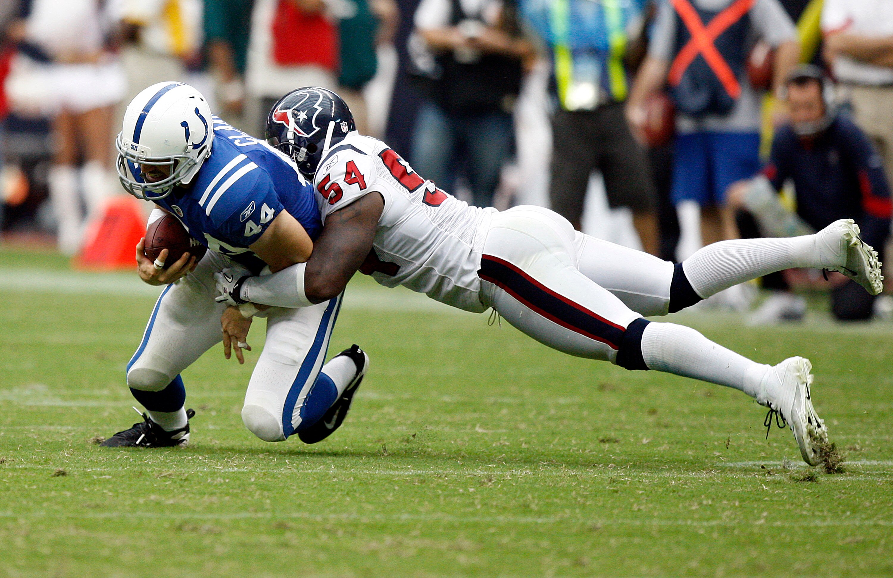 HOUSTON - SEPTEMBER 12:  Tight end Dallas Clark #44 of the Indianapolis Colts is tackled by linebacker Zac Diles #54 of the Houston Texans during the NFL season opener at Reliant Stadium on September 12, 2010 in Houston, Texas. Houston won 34-24. (Photo b