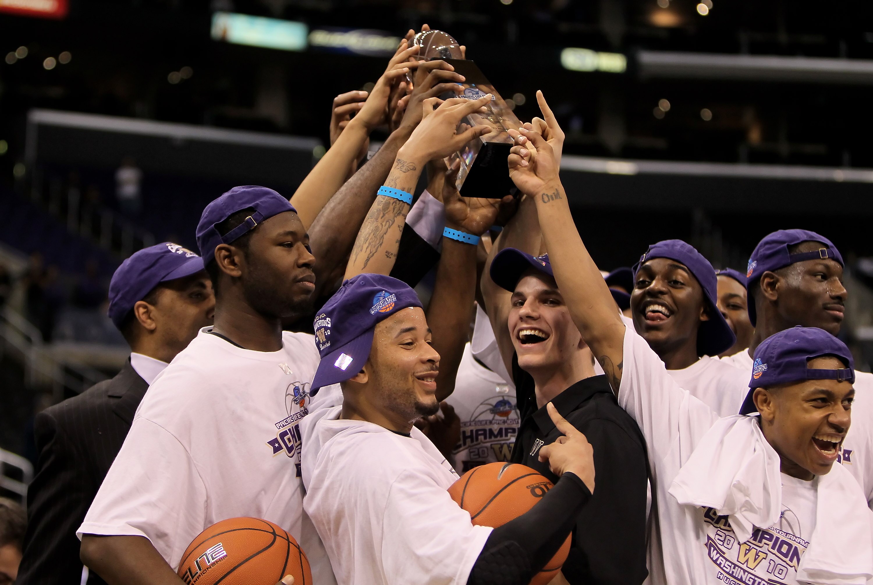 LOS ANGELES, CA - MARCH 13:  The Washington Huskies celebrate with the trophy following their victory over the Cal Golden Bears in the championship game of the Pac-10 Basketball Tournament at Staples Center on March 13, 2010 in Los Angeles, California. Wa