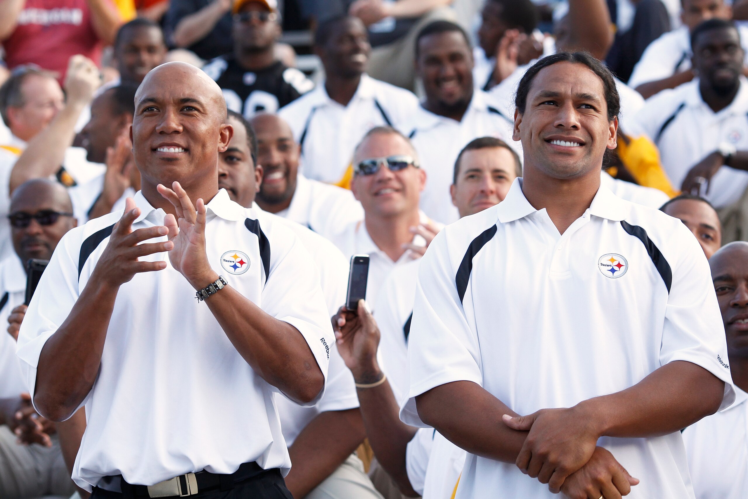 CANTON, OH - AUGUST 7: Hines Ward (L) and Troy Polamalu of the Pittsburgh Steelers look on as Dick LeBeau is introduced at the 2010 Pro Football Hall of Fame Enshrinement Ceremony at the Pro Football Hall of Fame Field at Fawcett Stadium on August 7, 2010