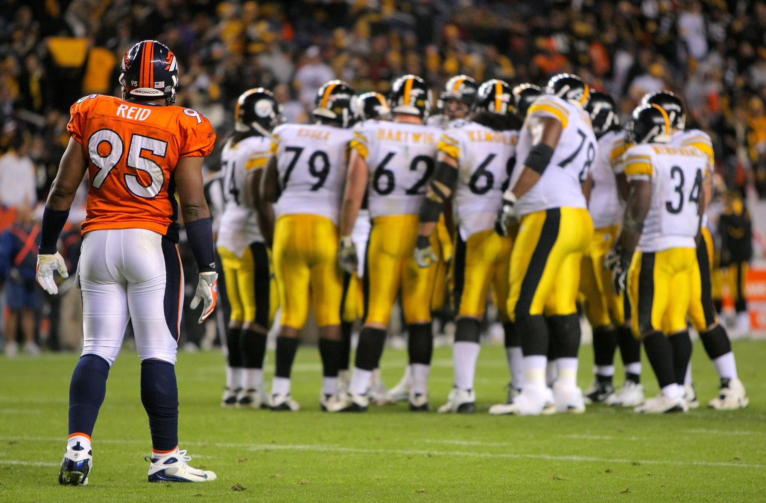 DENVER - NOVEMBER 09:  Defensive end Darrell Reid #95 of  the Denver Broncos waits for action at the line of scrimmage as quarterback Ben Roethlisberger #7 of the Pittsburgh Steelers runs the offensive huddle during NFL action at Invesco Field at Mile Hig