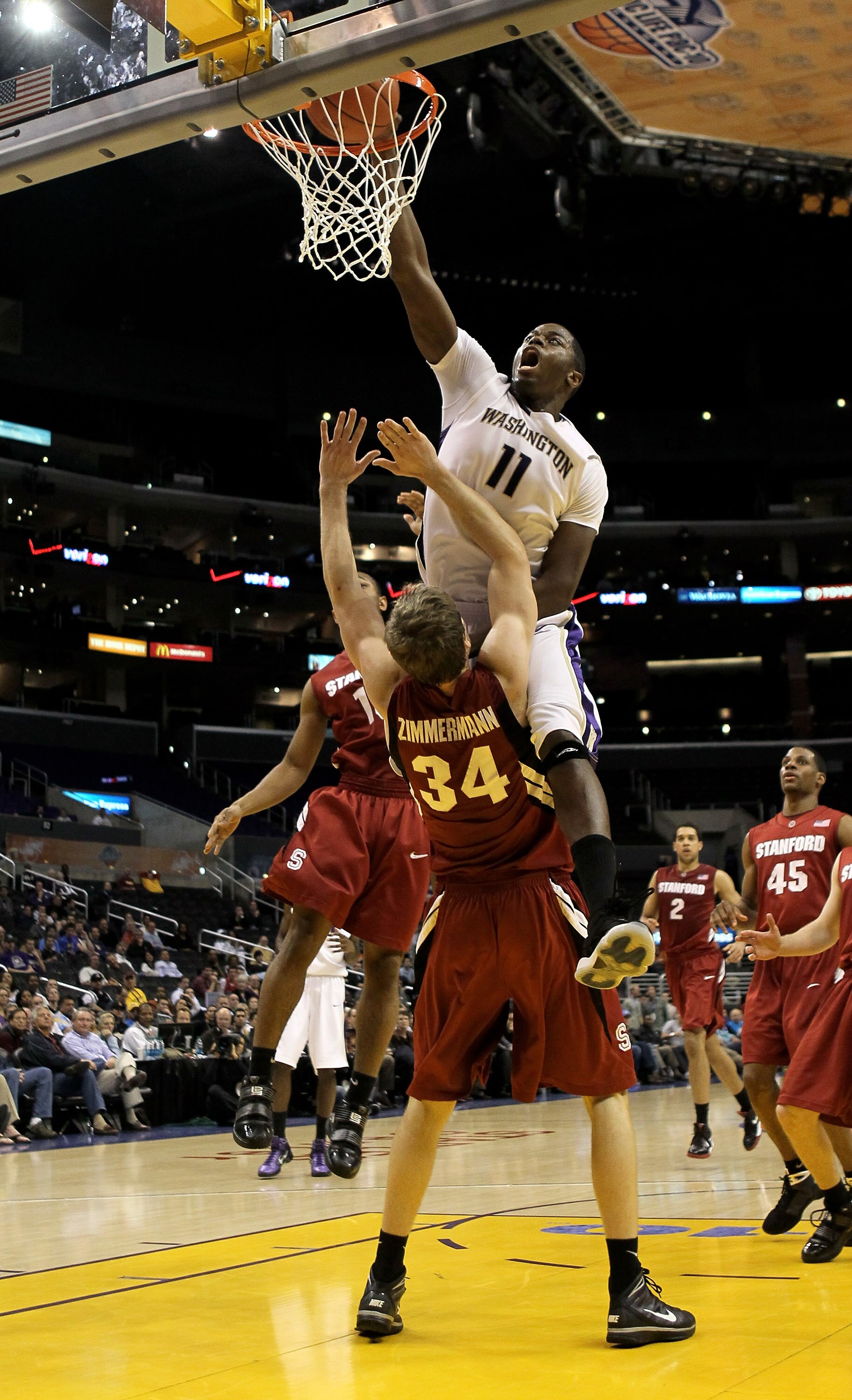 LOS ANGELES, CA - MARCH 12:  Matthew Bryan-Amaning #11 of the Washington Huskies dunks over Andrew Zimmermann #34 of the Stanford Cardinal during the semifinals of the Pac-10 Basketball Tournament at Staples Center on March 12, 2010 in Los Angeles, Califo