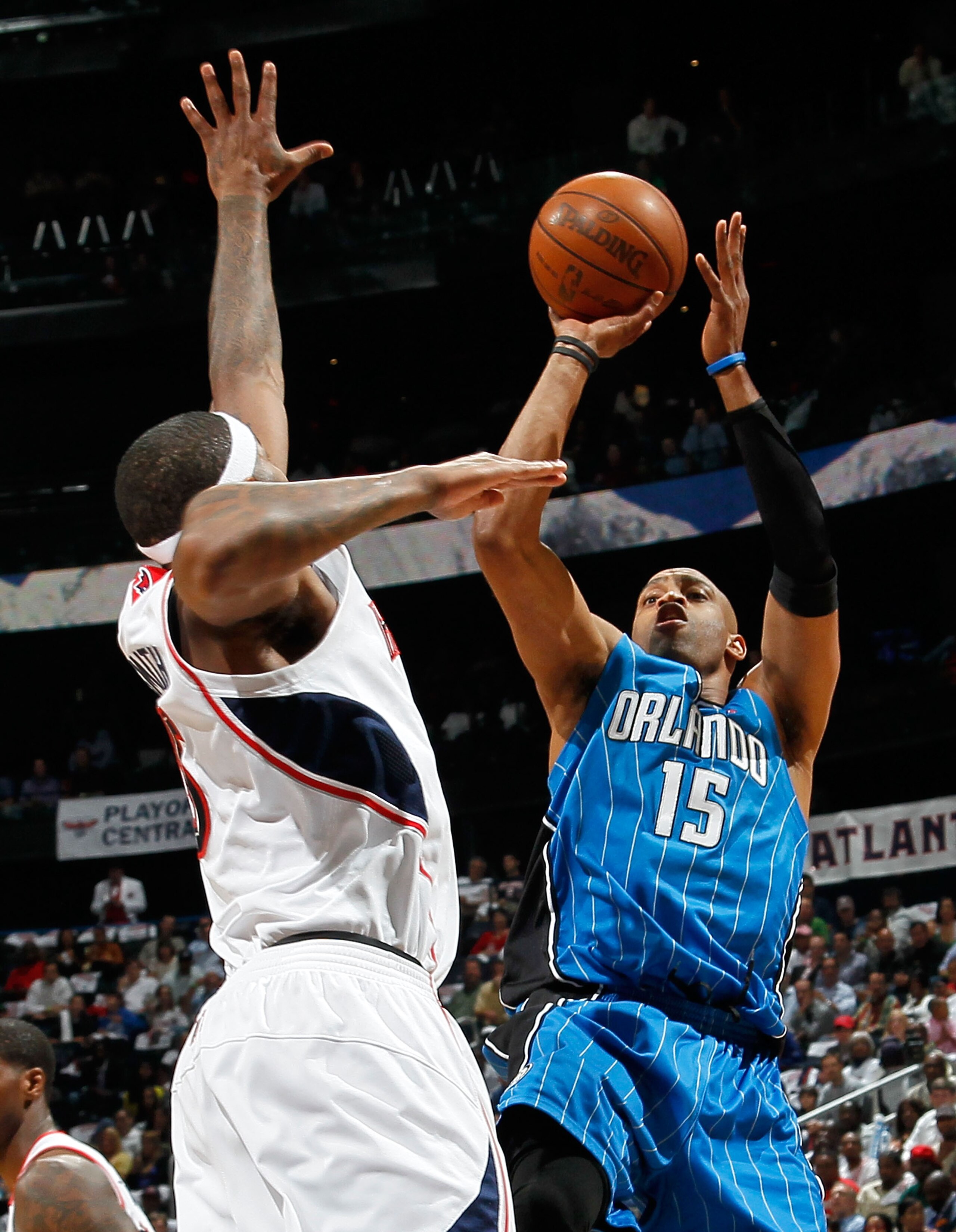 ATLANTA - MAY 10:  Vince Carter #15 of the Orlando Magic shoots against Josh Smith #5 of the Atlanta Hawks during Game Four of the Eastern Conference Semifinals of the 2010 NBA Playoffs at Philips Arena on May 10, 2010 in Atlanta, Georgia.  NOTE TO USER: