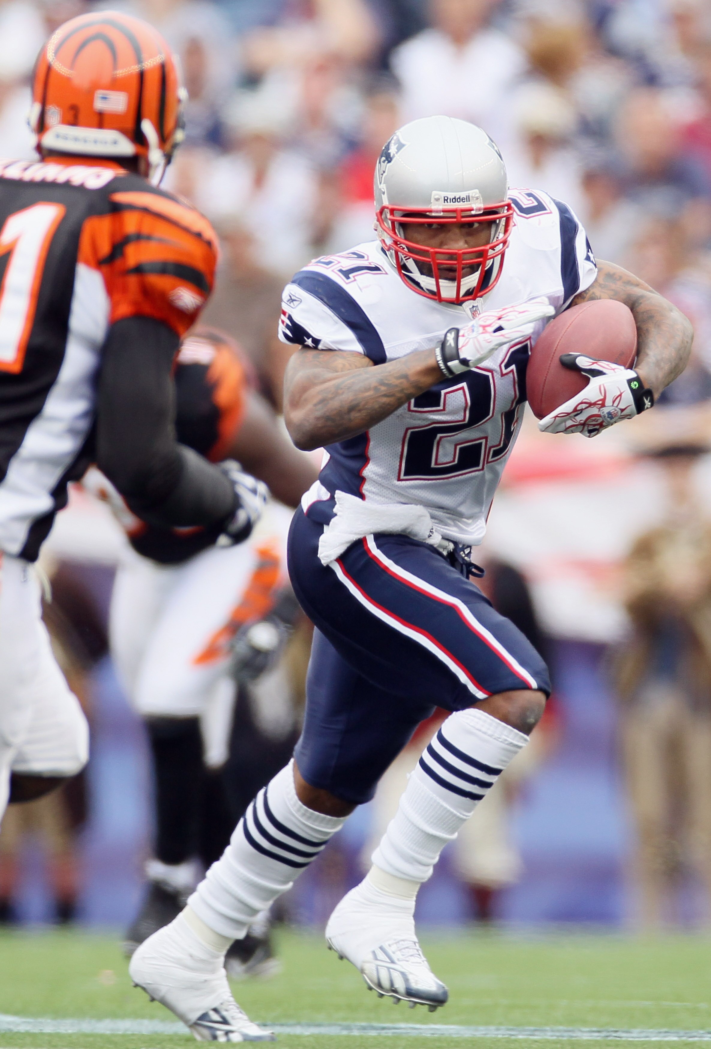 FOXBORO, MA - SEPTEMBER 12:  Fred Taylor #21 of the New England Patriots carries the ball as Roy Williams #31 defends during the NFL season opener on September 12, 2010 at Gillette Stadium in Foxboro, Massachusetts. The Patriots defeated the Bengals 38-24