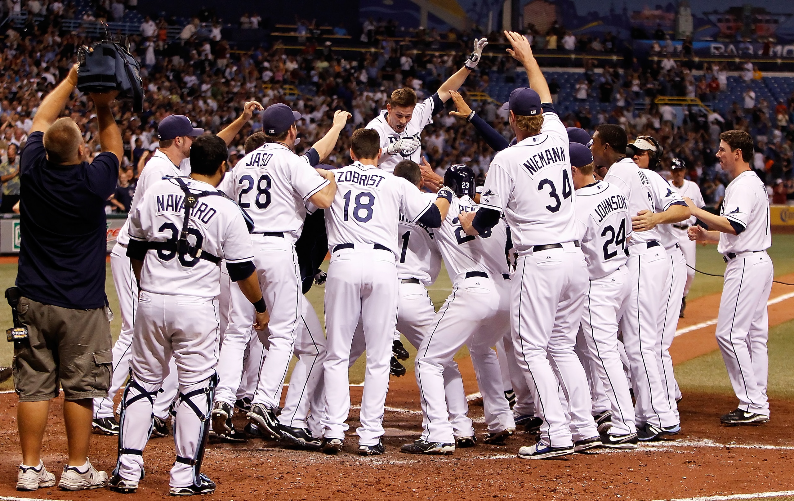 ST. PETERSBURG - SEPTEMBER 13:  Reid Brignac #15 of the Tampa Bay Rays touches home plate after a walk-off home run in the bottom of the 11th inning against the New York Yankees at Tropicana Field on September 13, 2010 in St. Petersburg, Florida.  (Photo 