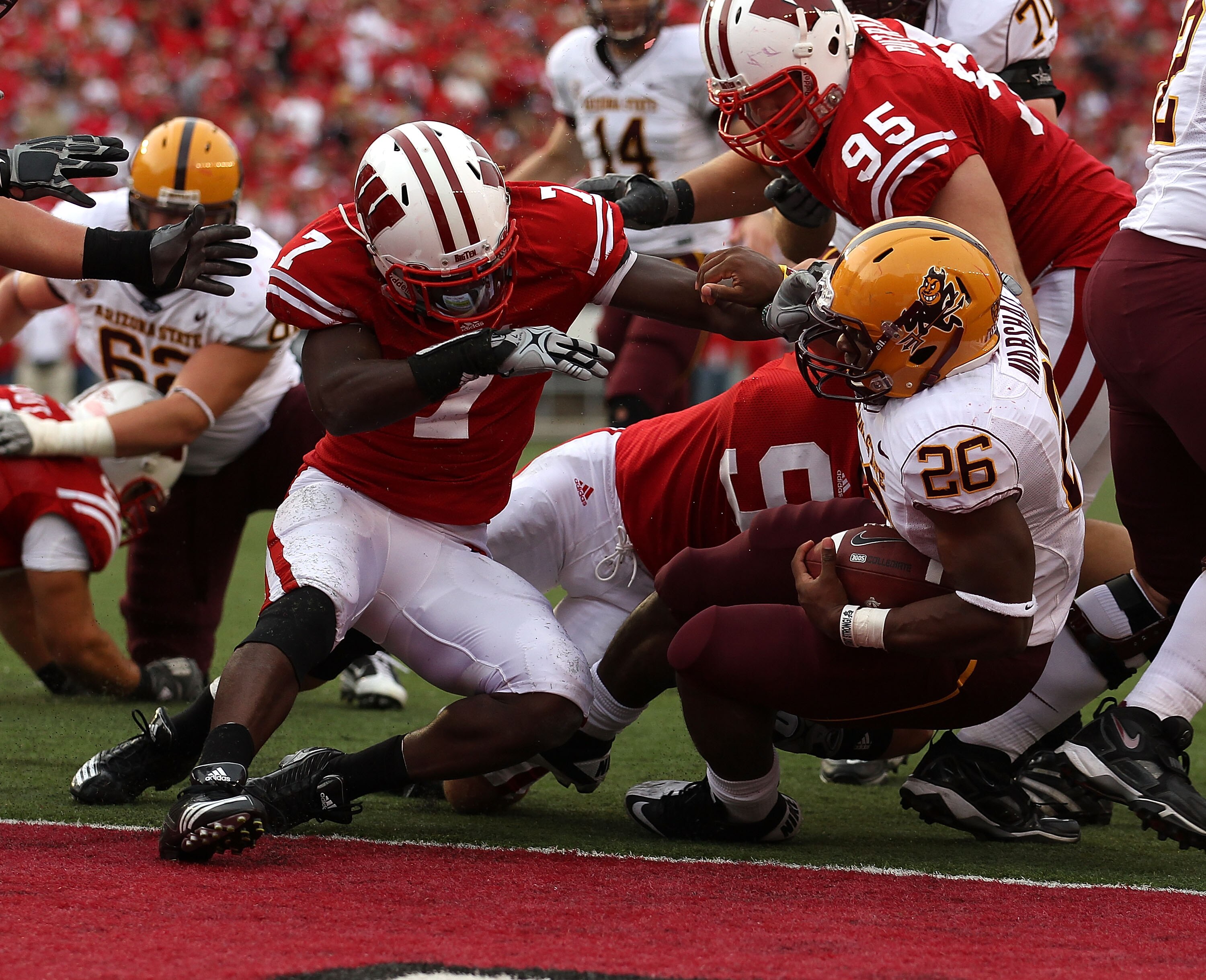 MADISON, WI - SEPTEMBER 18: Cameron Marshall #26 of the Arizona State Sun Devils crosses the goal line to score a touchdown in the 4th quarter as Aaron Henry #7 of the Wisconsin Badgers tries for the tackle at Camp Randall Stadium on September 18, 2010 in