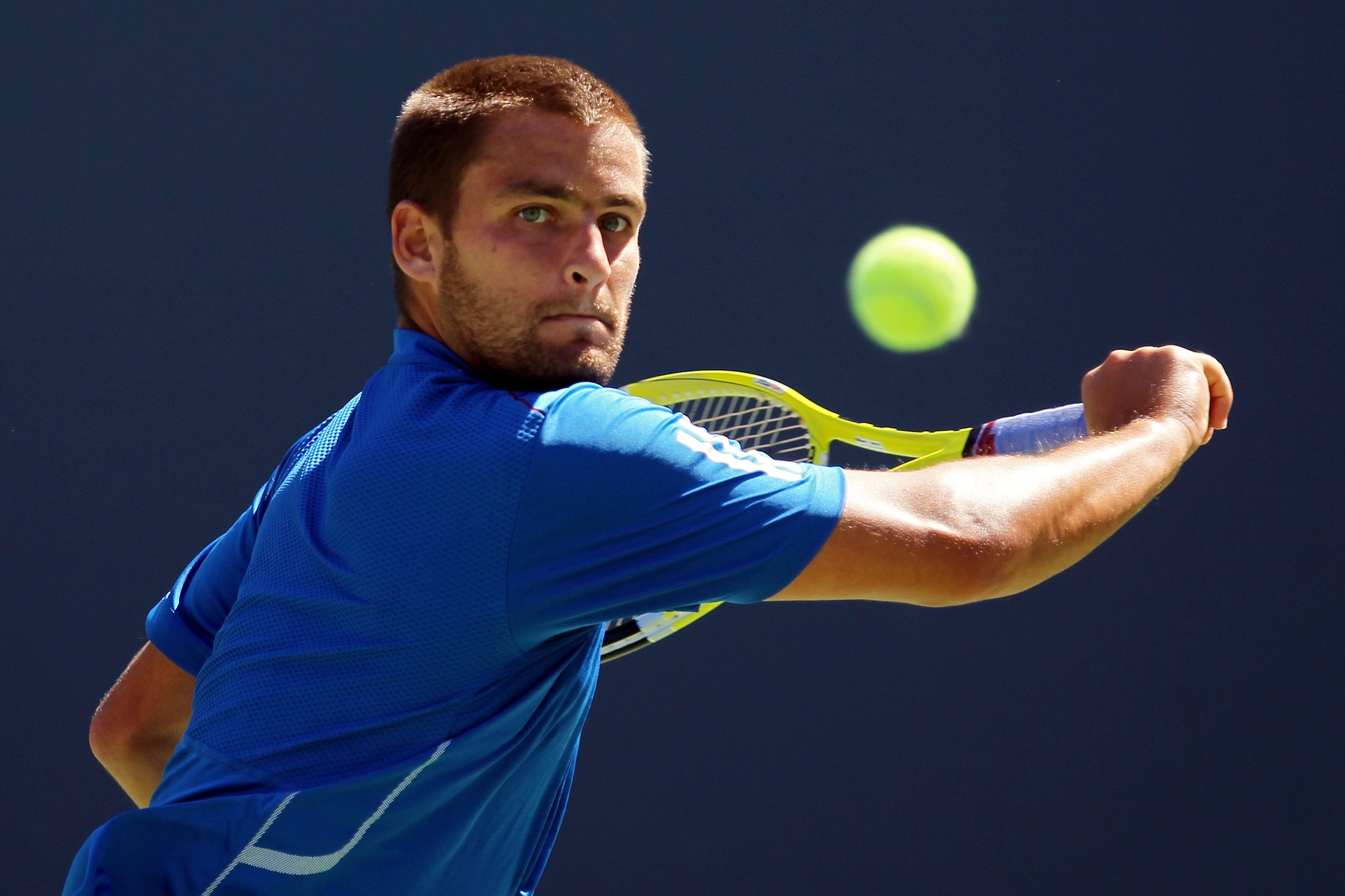 NEW YORK - SEPTEMBER 11:  Mikhail Youzhny of Russia returns a shot while playing against Rafael Nadal of Spain during his men's singles semifinal match on day thirteen of the 2010 U.S. Open at the USTA Billie Jean King National Tennis Center on September
