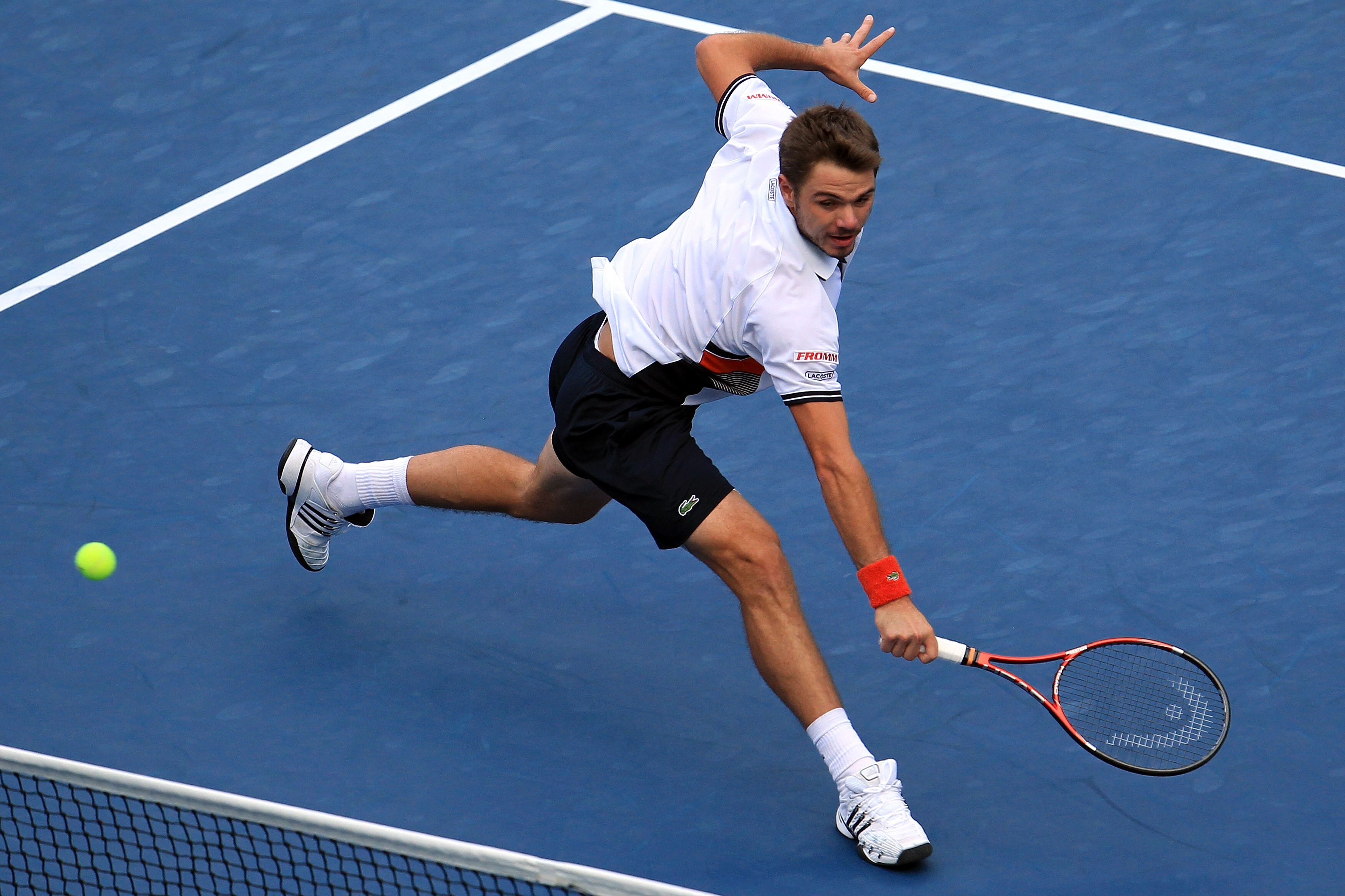NEW YORK - SEPTEMBER 09:  Stanislas Wawrinka of Switzerland returns a shot against Mikhail Youzhny of Russia during his men's single quarterfinal match on day eleven of the 2010 U.S. Open at the USTA Billie Jean King National Tennis Center on September 9,