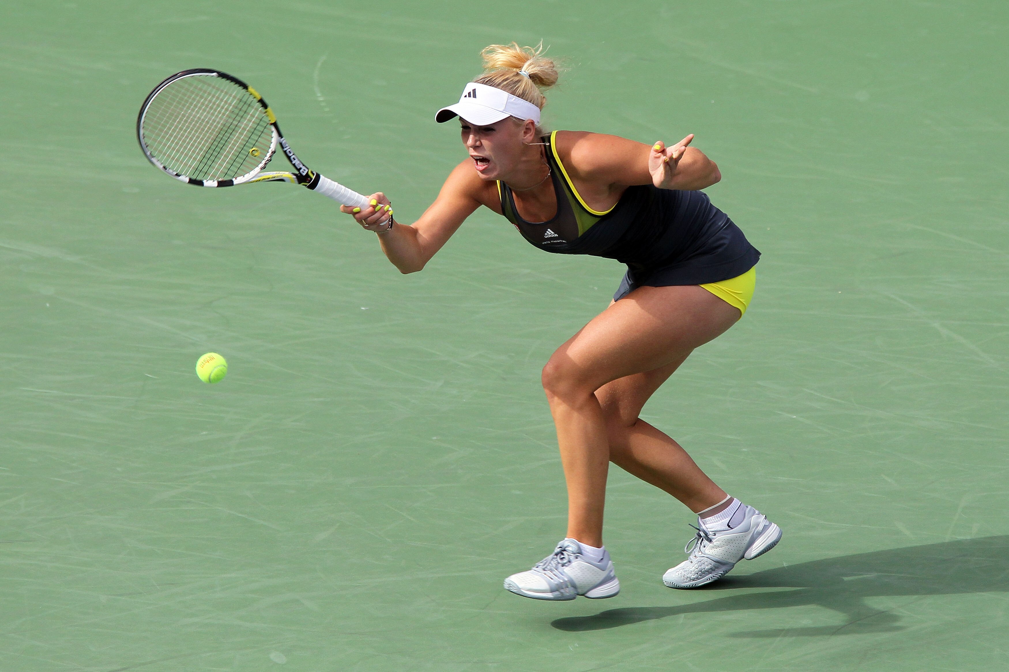 NEW YORK - SEPTEMBER 10:  Caroline Wozniacki of Denmark returns a shot against Vera Zvonareva of Russia during her women's semifinal match on day twelve of the 2010 U.S. Open at the USTA Billie Jean King National Tennis Center on September 10, 2010 in the