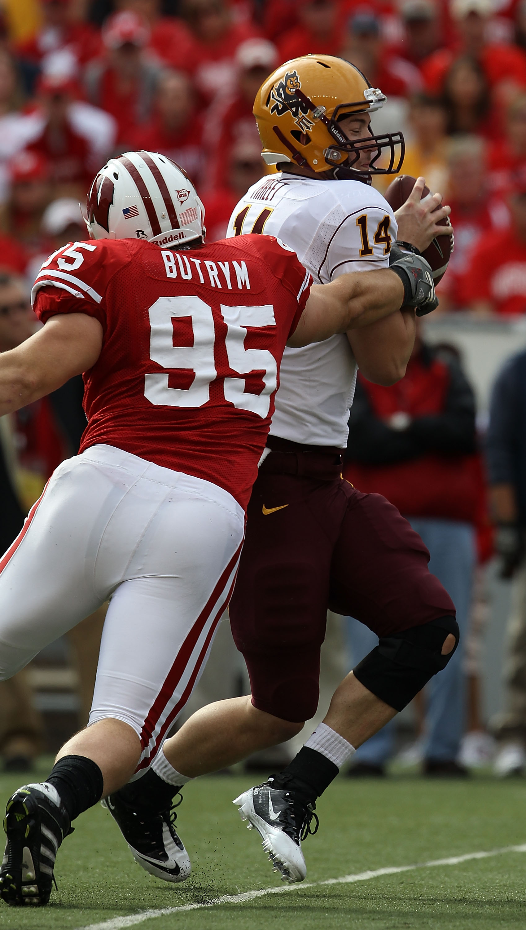 MADISON, WI - SEPTEMBER 18: Patirck Butrym #95 of the Wisconsin Badgers grabs Steven Threet #14 of the Arizona State Sun Devils as he looks for a receiver at Camp Randall Stadium on September 18, 2010 in Madison, Wisconsin. Wisconsin defeated Arizona Stat