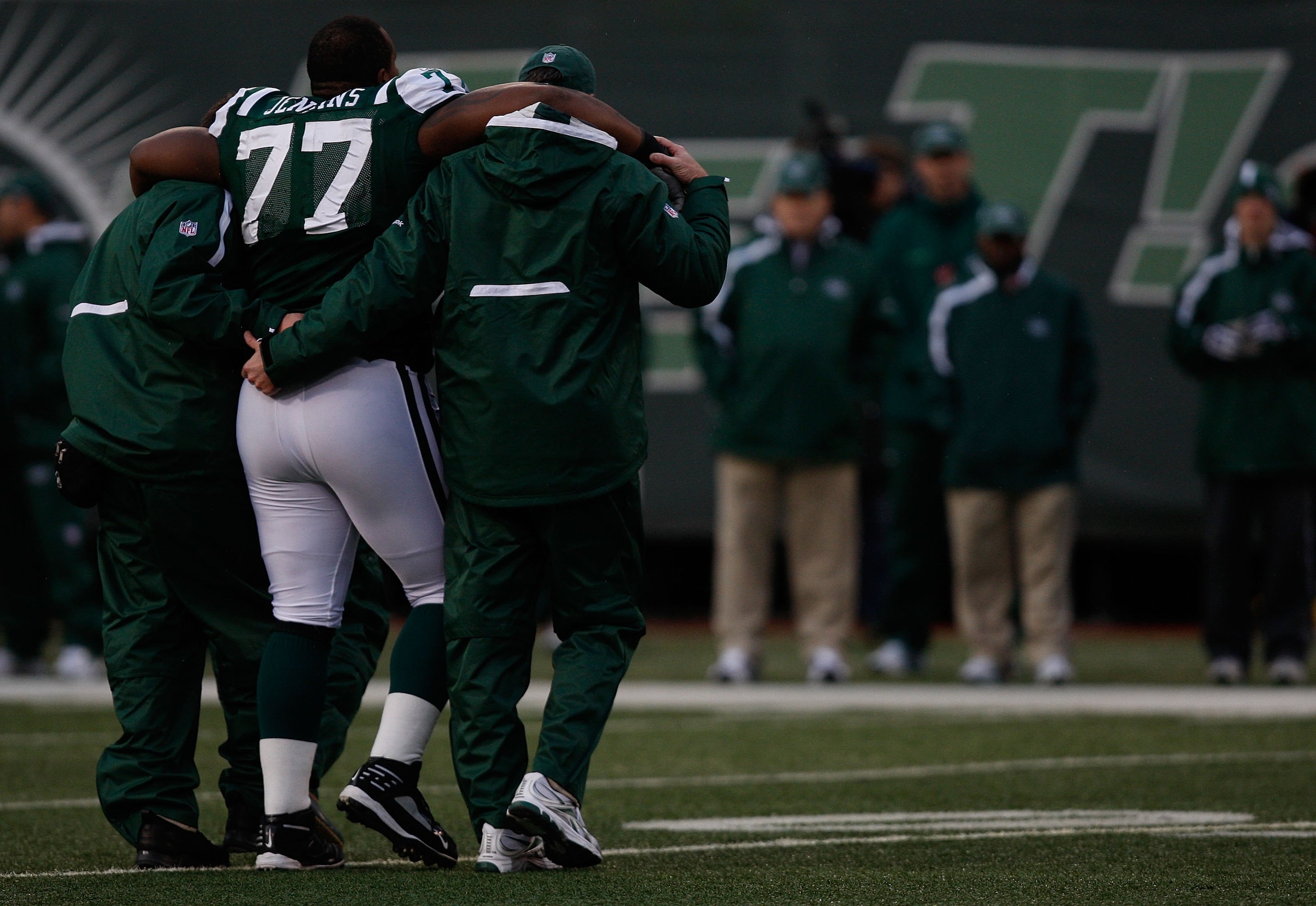 EAST RUTHERFORD, NJ - OCTOBER 18: Kris Jenkins #77 of the New York Jets walks off the field with an injury with help from the medical staff against the Buffalo Bills during the game on October 18, 2009 at Giants Stadium in East Rutherford, New Jersey. The