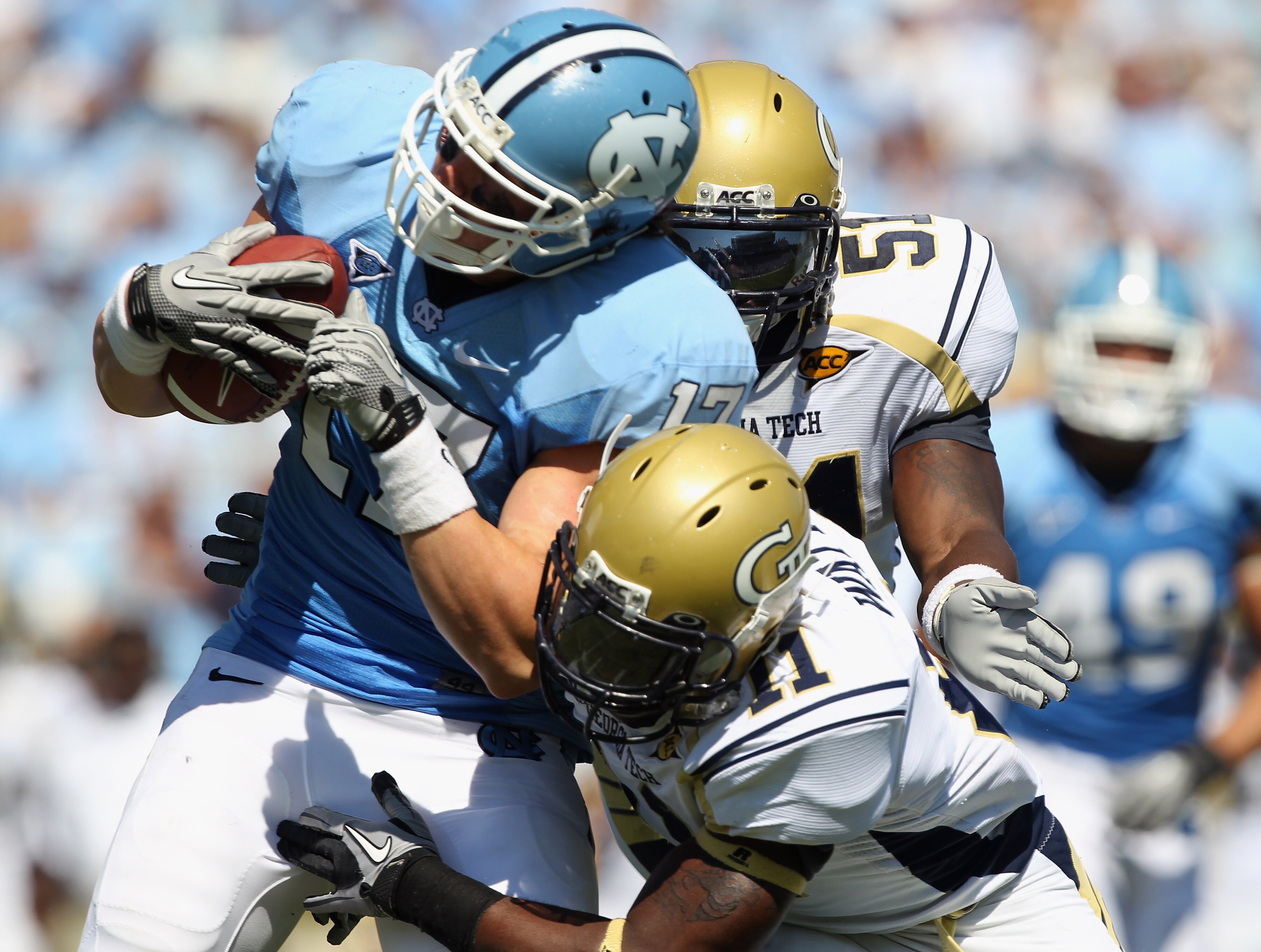 CHAPEL HILL, NC - SEPTEMBER 18:  Teammates Brandon Watts #11 and Brad Jefferson of the Georgia Tech Yellow Jackets tackle Zack Pianalto #17 of the North Carolina Tar Heels during their game at Kenan Stadium on September 18, 2010 in Chapel Hill, North Caro