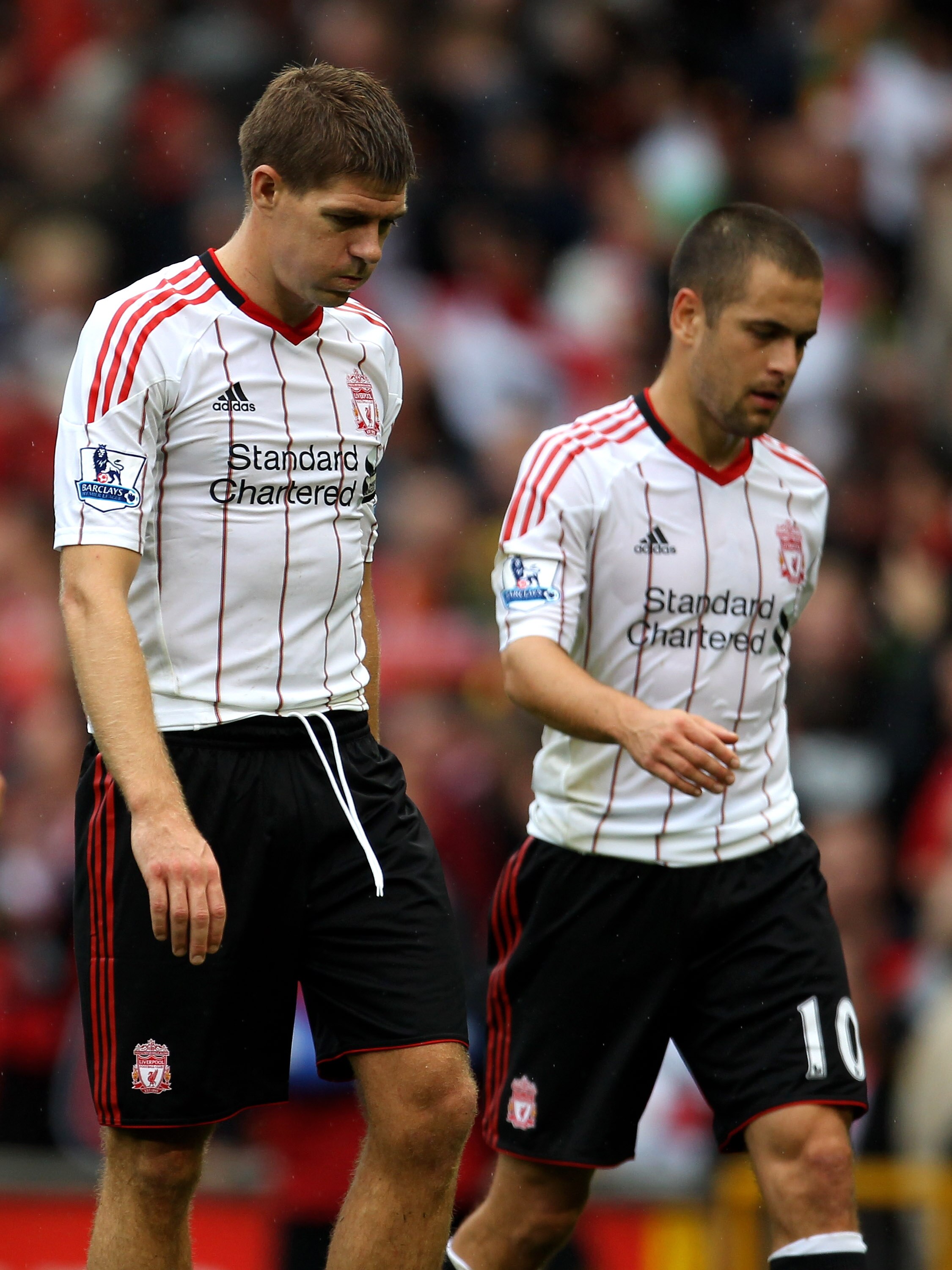 MANCHESTER, ENGLAND - SEPTEMBER 19: Steven Gerrard of Liverpool leaves the pitch with team mate Joe Cole at the end of the Barclays Premier League match between Manchester United and Liverpool at Old Trafford on September 19, 2010 in Manchester, England. MANCHESTER, ENGLAND - SEPTEMBER 19: Steven Gerrard of Liverpool leaves the pitch with team mate Joe Cole at the end of the Barclays Premier League match between Manchester United and Liverpool at Old Trafford on September 19, 2010 in Manchester, England.