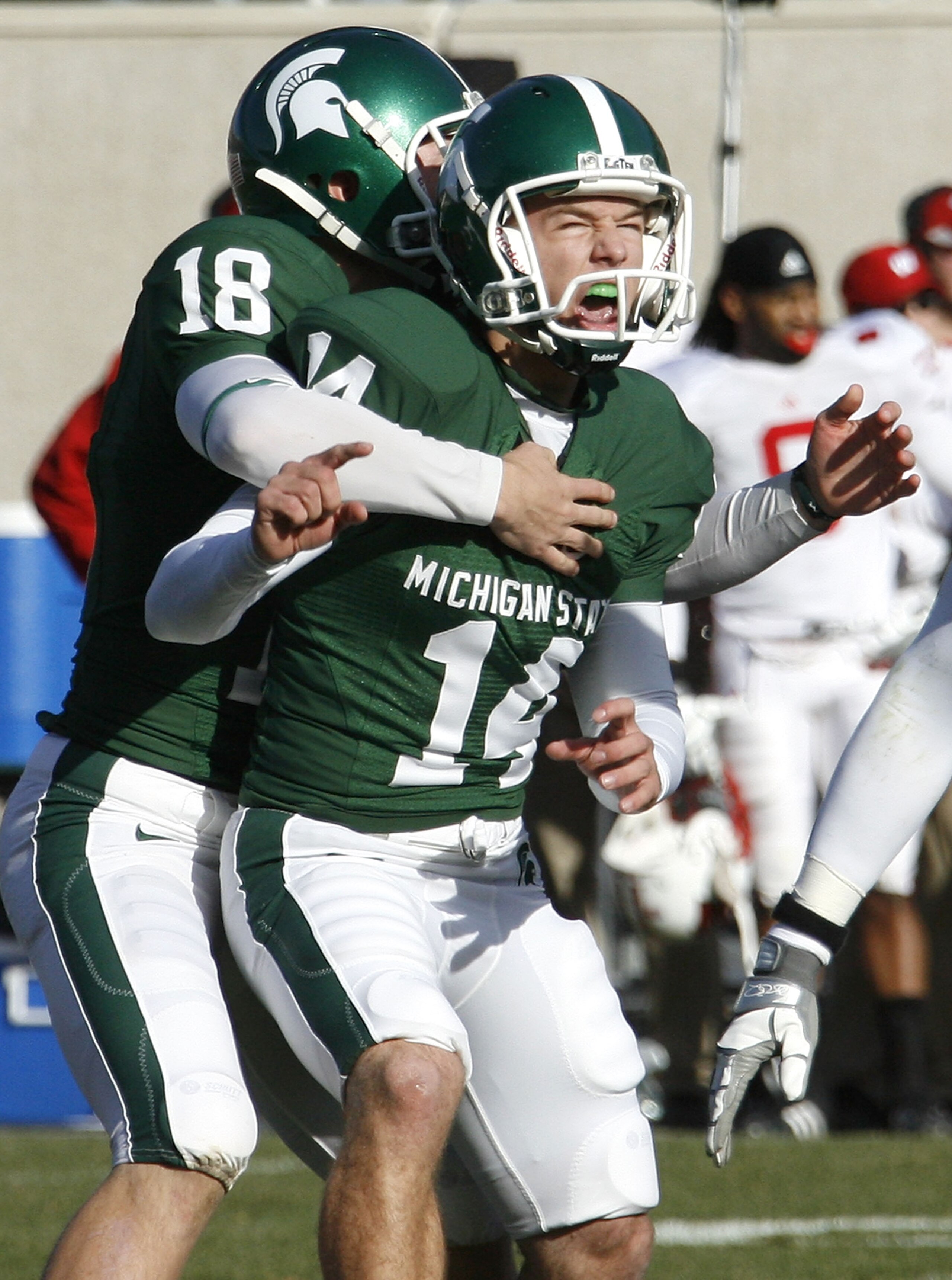 EAST LANSING, MI - NOVEMBER 01:  Brett Swenson #14 of the Michigan State Spartans reacts with Aaron Bates #18 after kicking game winning field goal to beat the Wisconsin Badgers 25-24 on November 1, 2008 at Spartan Stadium in East Lansing, Michigan.  (Pho