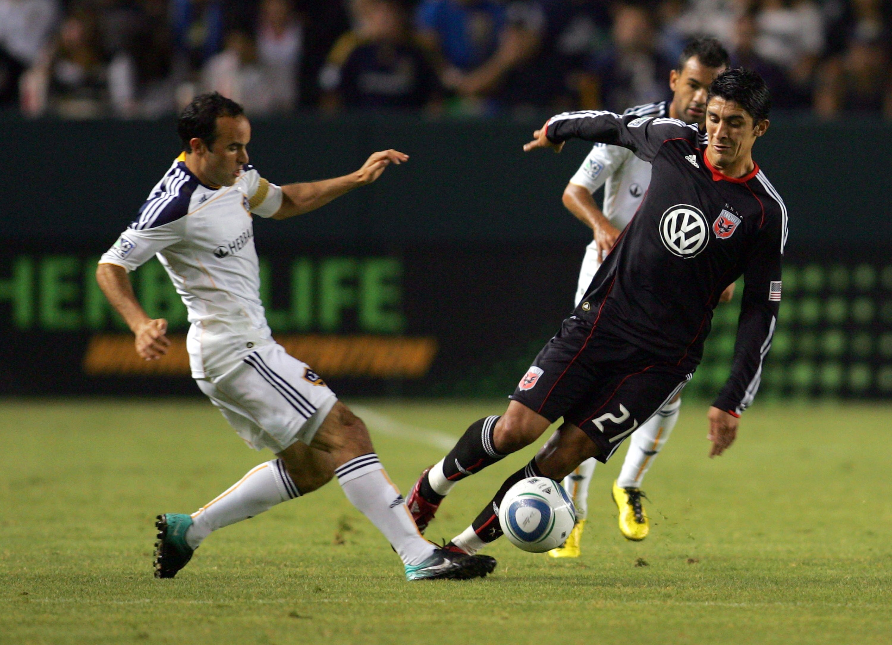 CARSON, CA - SEPTEMBER 18:  Landon Donovan #10 of the Los Angeles Galaxy challenges Pablo Hernandez #21 of D.C. United for the ball in the first half during the MLS match at The Home Depot Center on September 18, 2010 in Carson, California.  (Photo by Vic