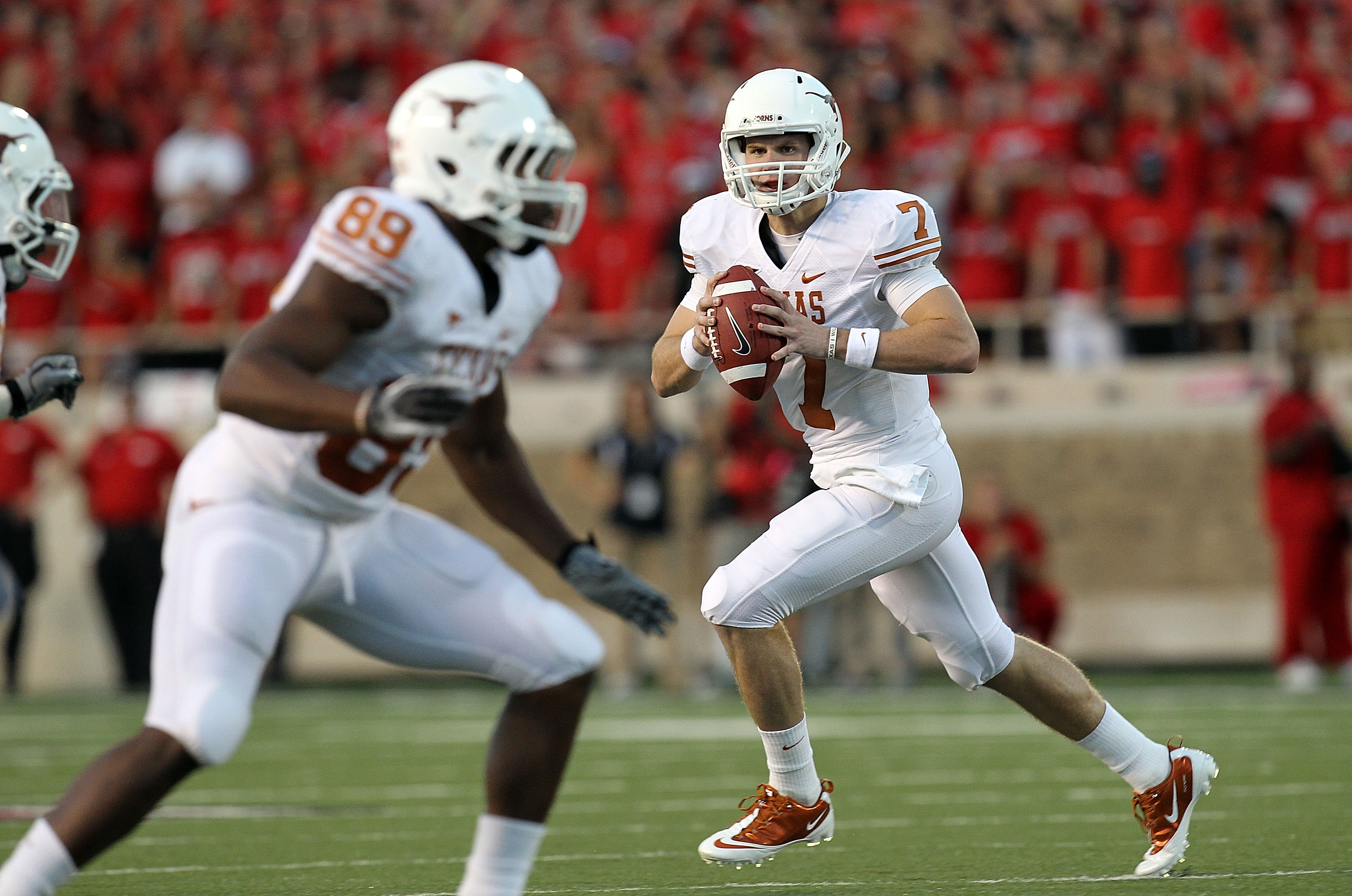 LUBBOCK, TX - SEPTEMBER 18:  Quarterback Garrett Gilbert #7 of the Texas Longhorns looks to pass against the Texas Tech Red Raiders at Jones AT&T Stadium on September 18, 2010 in Lubbock, Texas.  (Photo by Ronald Martinez/Getty Images)