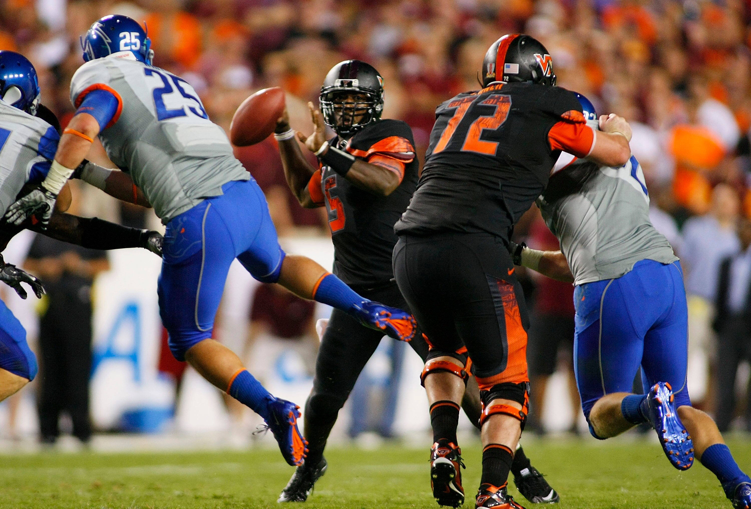 LANDOVER, MD - SEPTEMBER 06:  Quarterback Tyrod Taylor #5 of the Virginia Tech Hokies passes the ball as linebacker Hunter White #25 of the Boise State Broncos defends at FedExField on September 6, 2010 in Landover, Maryland.  (Photo by Geoff Burke/Getty