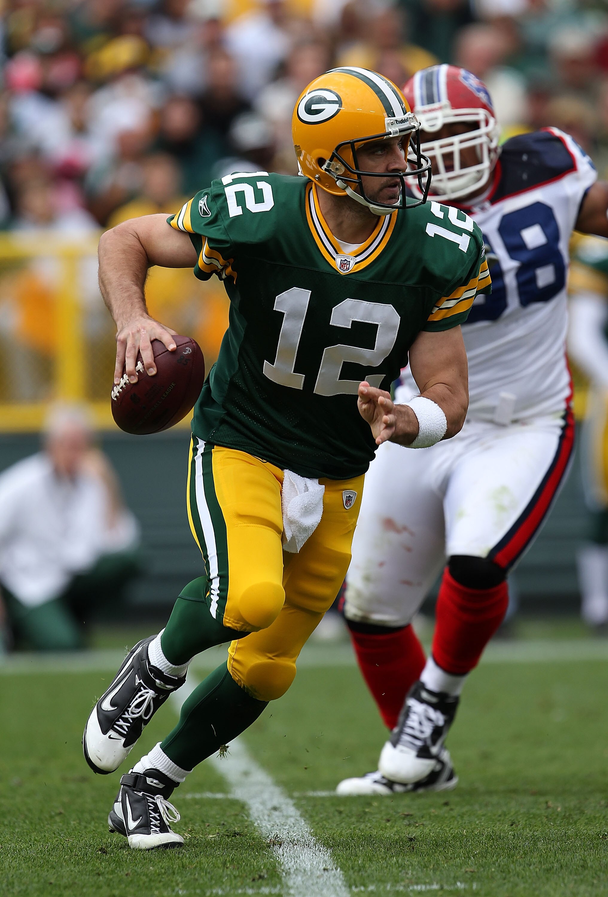GREEN BAY, WI - SEPTEMBER 19: Aaron Rodgers #12 of the Green Bay Packers rolls out to look for a receiver against the Buffalo Bills at Lambeau Field on September 19, 2010 in Green Bay, Wisconsin. The Packers defeated the Bills 34-7.  (Photo by Jonathan Da