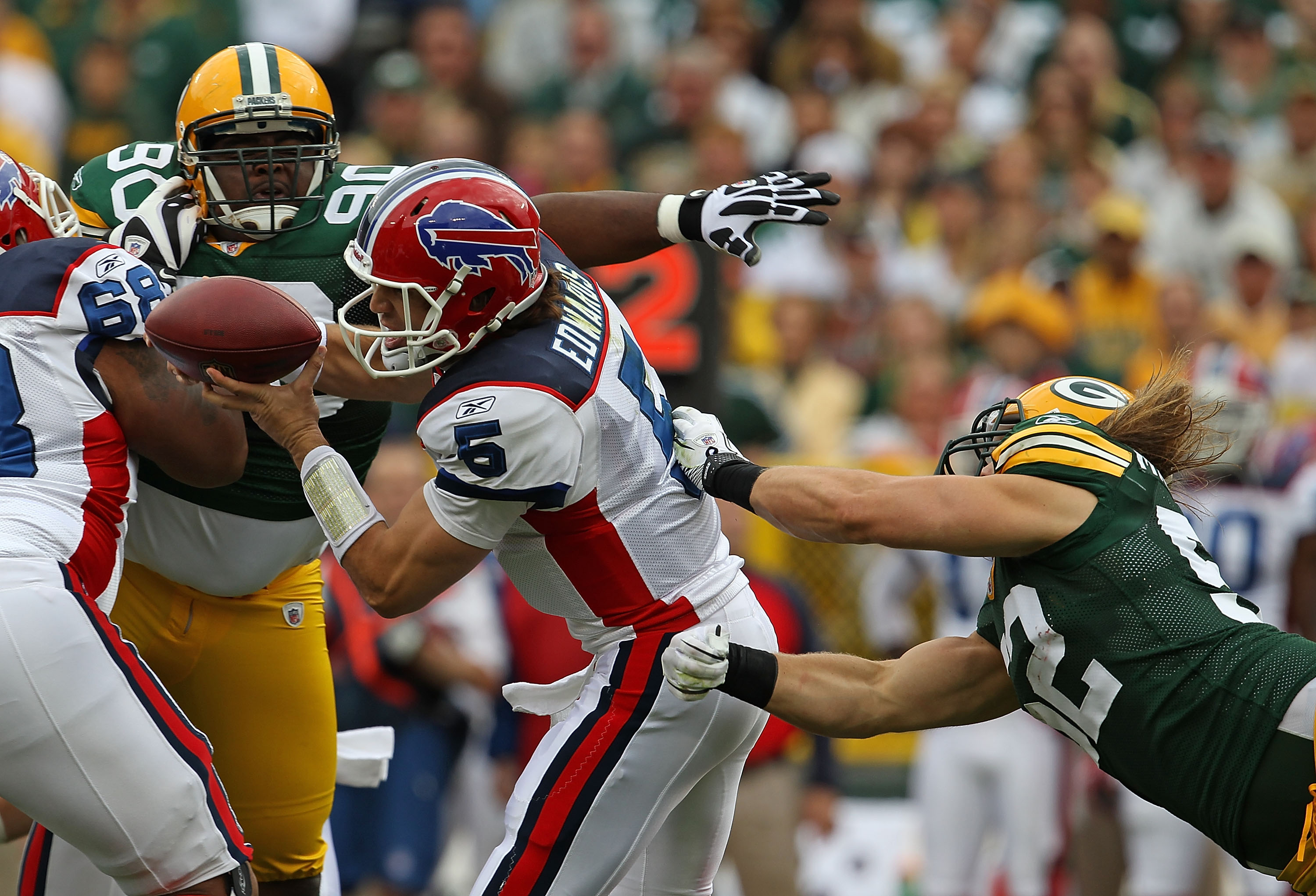 GREEN BAY, WI - SEPTEMBER 19: Trent Edwards #5 of the Buffalo Bills tries to avoid B.J. Raji #90 and Clay Matthews #52 of the Green Bay Packers at Lambeau Field on September 19, 2010 in Green Bay, Wisconsin. The Packers defeated the Bills 34-7. (Photo by 