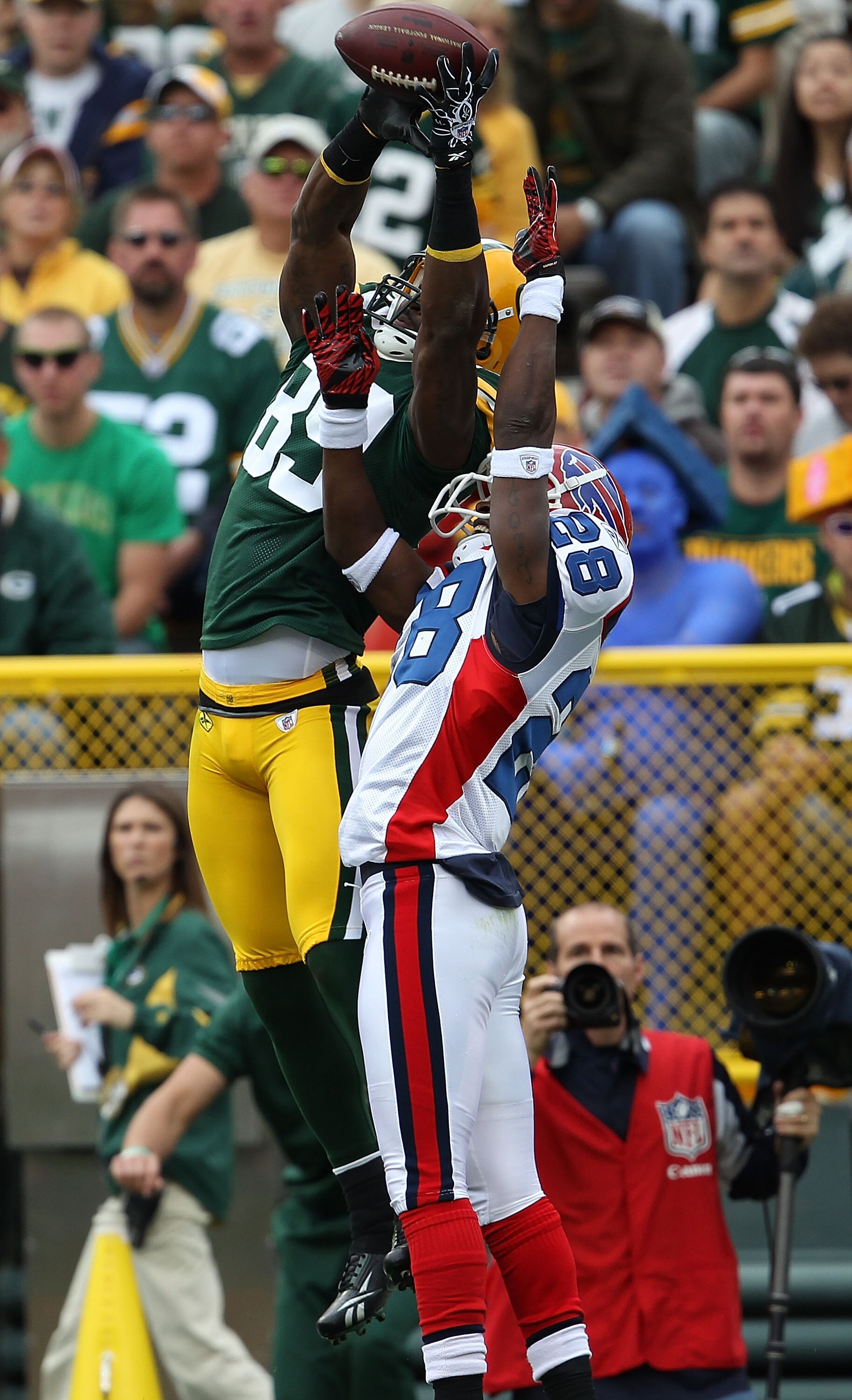GREEN BAY, WI - SEPTEMBER 19: James Jones #89 of the Green Bay Packers leaps to try and catch a pass under pressure from Leodis McKelvin #28 of the Buffalo Bills at Lambeau Field on September 19, 2010 in Green Bay, Wisconsin. The Packers defeated the Bill