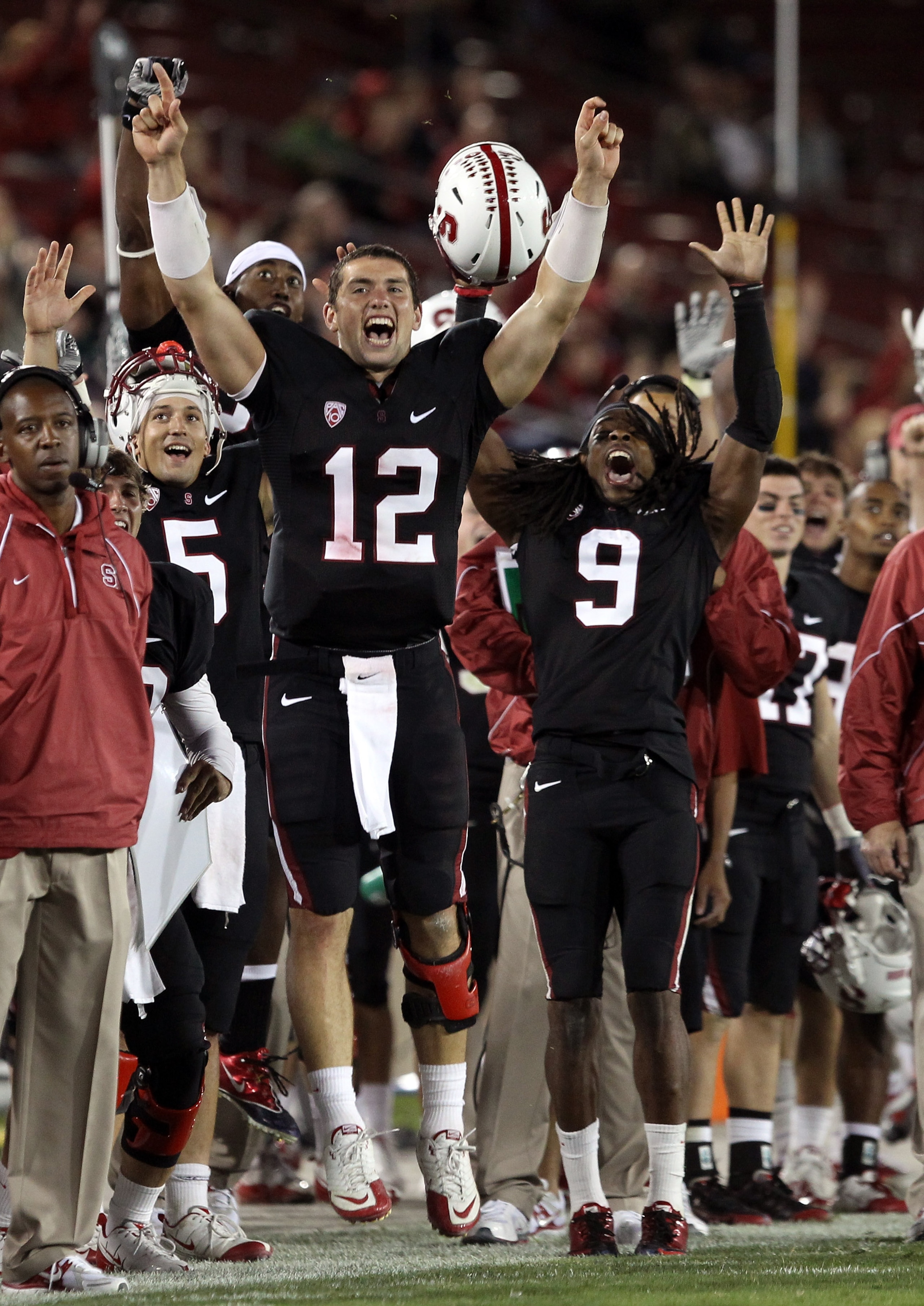 PALO ALTO, CA - SEPTEMBER 18:  Andrew Luck #12 and Richard Sherman #9 of the Stanford Cardinal celebrate from the sidelines after Stanford scored a touchdown to go up 67-24 in the fourth quarter of their game against the Wake Forest Demon Deacons at Stanf