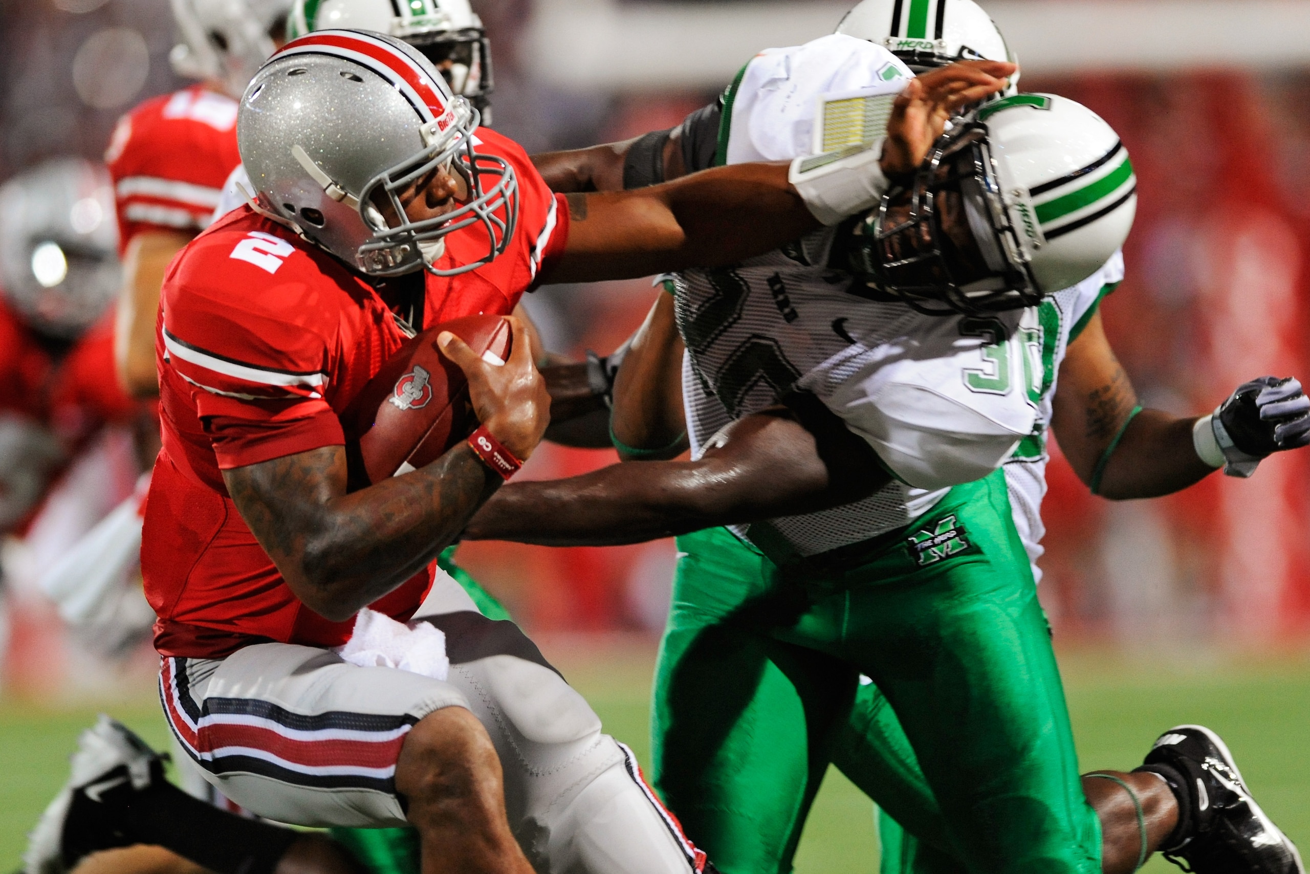 COLUMBUS, OH - SEPTEMBER 2:  Terrelle Pryor #2 of the Ohio State Buckeyes stiff arms Mario Harvey #30 of the Marshall Thundering Herd at Ohio Stadium on September 2, 2010 in Columbus, Ohio.  (Photo by Jamie Sabau/Getty Images)