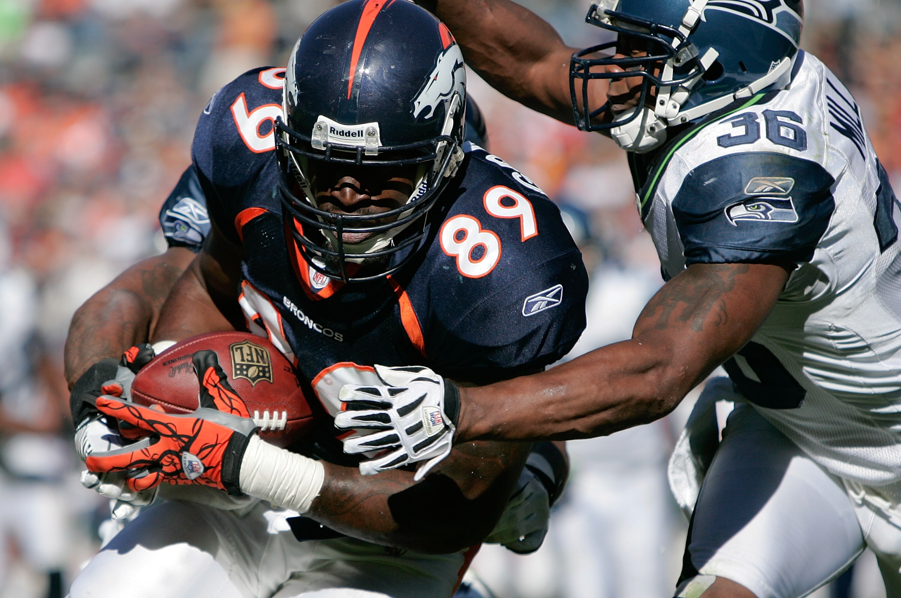DENVER - SEPTEMBER 19:  Tight end Daniel Graham #89 of the Denver Broncos is tackled by safety Lawyer Milloy #36 of the Seattle Seahawks during NFL action at INVESCO Field at Mile High on September 19, 2010 in Denver, Colorado.  (Photo by Justin Edmonds/G