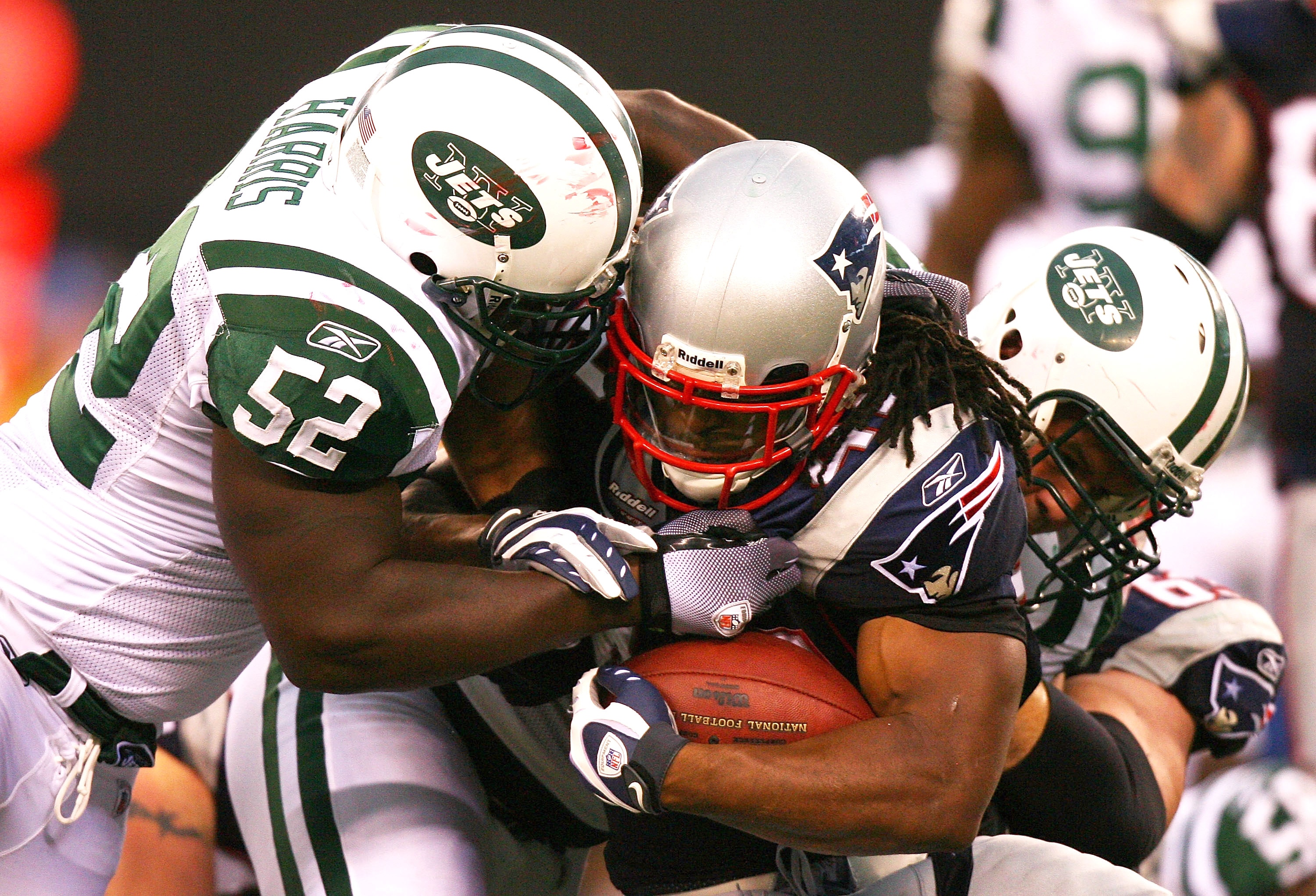 EAST RUTHERFORD, NJ - SEPTEMBER 19: BenJarvus Green-Ellis #42 of the New England Patriots is tackled by David Harris #52 of the New York Jets at the New Meadowlands Stadium on September 19, 2010 in East Rutherford, New Jersey. The Jets defeated the Patrio