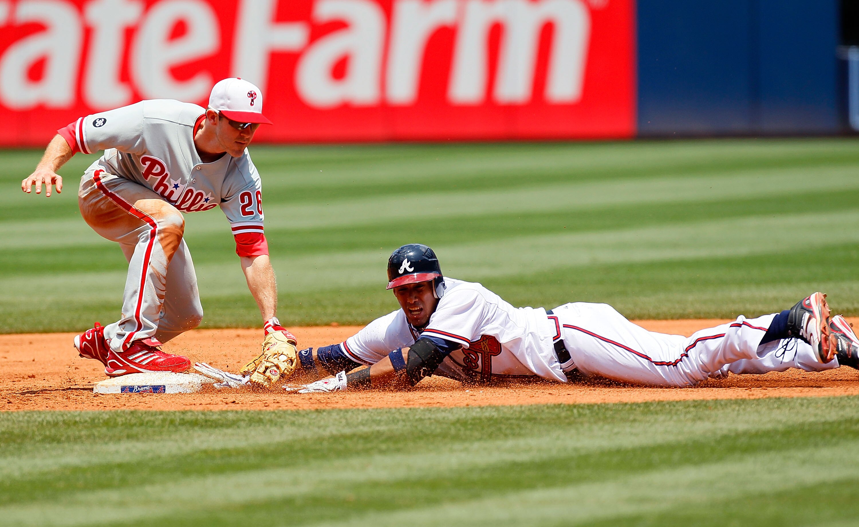 ATLANTA - MAY 31:  Yunel Escobar #19 of the Atlanta Braves is tagged out at second base by Chase Utley #26 of the Philadelphia Phillies in the third inning at Turner Field on May 31, 2010 in Atlanta, Georgia.  (Photo by Kevin C. Cox/Getty Images)