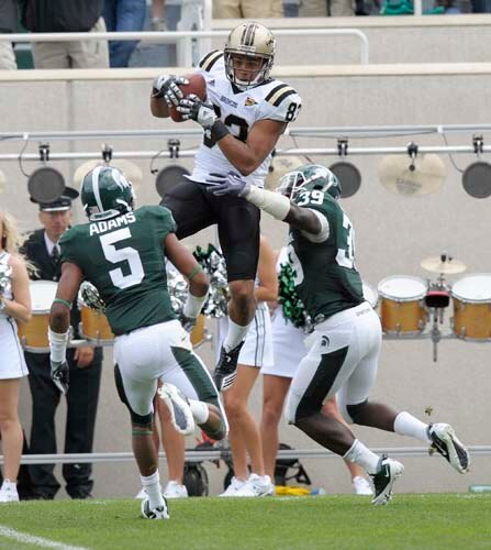 Jordan White leaps over Michigan State defenders to make the catch.