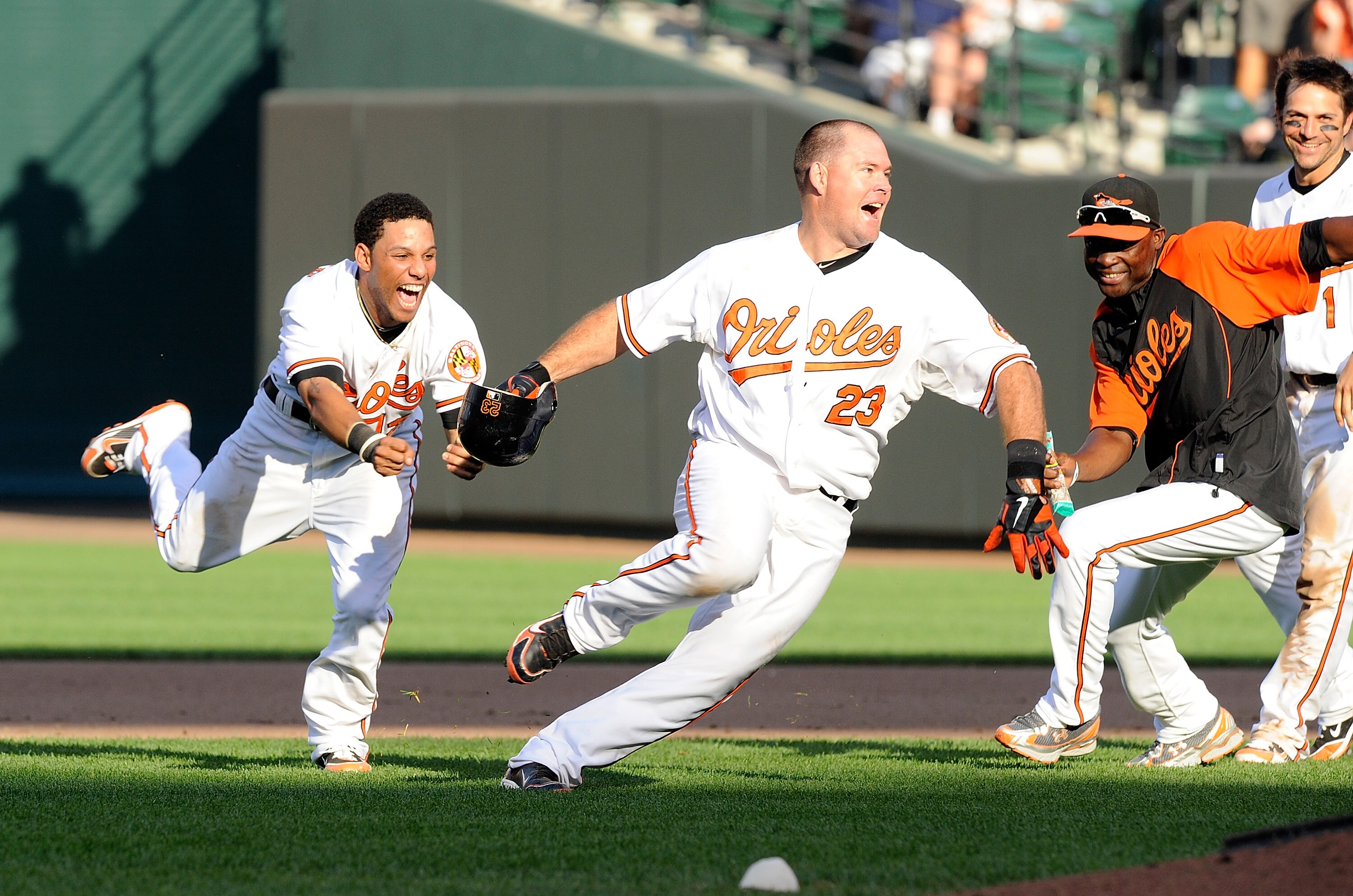 BALTIMORE - SEPTEMBER 19: Ty Wigginton #23 of the Baltimore Orioles is chased by Robert Andino #12 after driving in the game winning run in the eleventh inning against the New York Yankees at Camden Yards on September 19, 2010 in Baltimore, Maryland. The BALTIMORE - SEPTEMBER 19: Ty Wigginton #23 of the Baltimore Orioles is chased by Robert Andino #12 after driving in the game winning run in the eleventh inning against the New York Yankees at Camden Yards on September 19, 2010 in Baltimore, Maryland. The