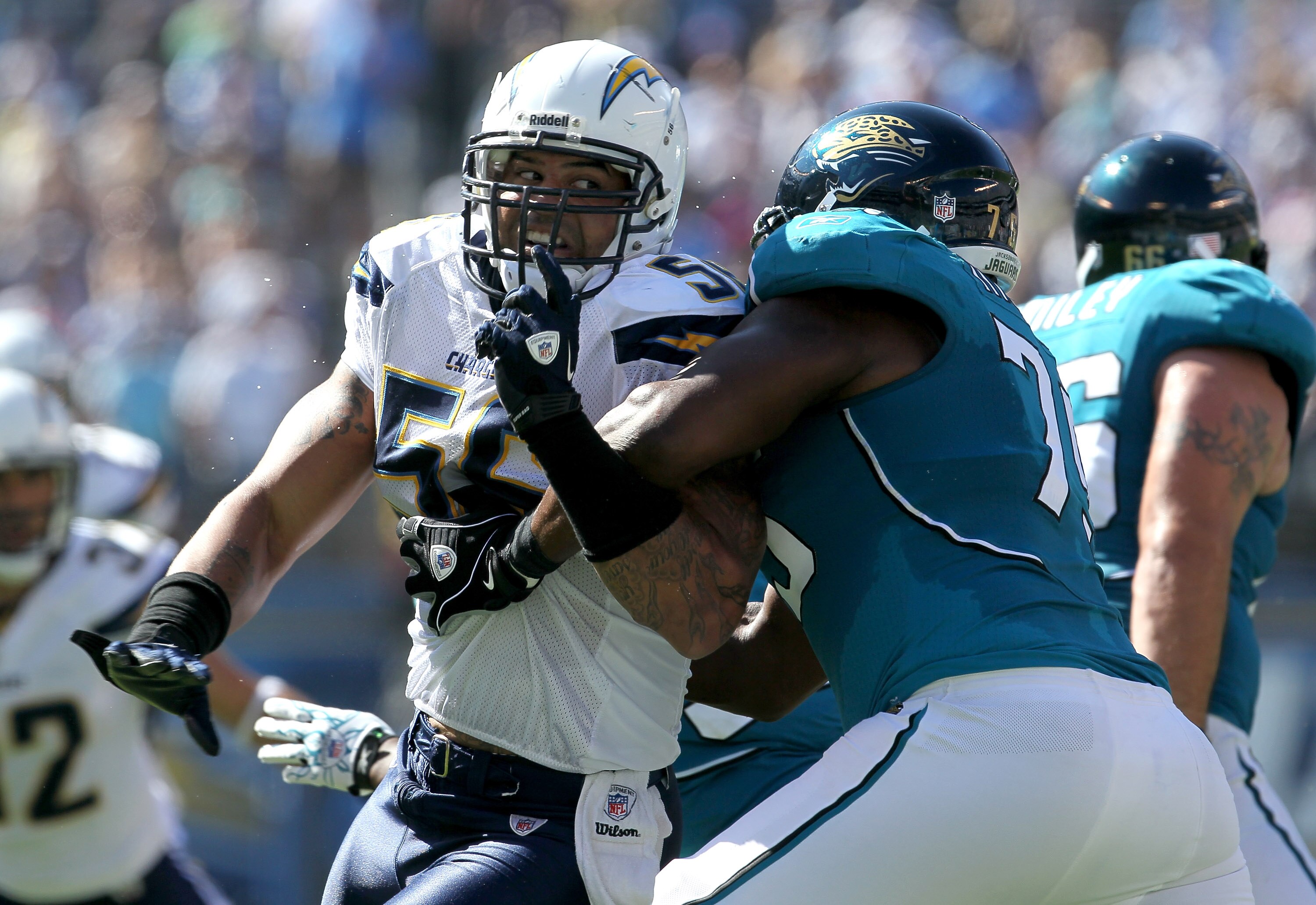 SAN DIEGO - SEPTEMBER 19:  Linebacker Shawne Merriman #56 of the San Diego Chargers fights against the block of tackle Eugene Monroe #75 of the Jacksonville Jaguars at Qualcomm Stadium on September 19, 2010 in San Diego, California. The Chargers won 38-13