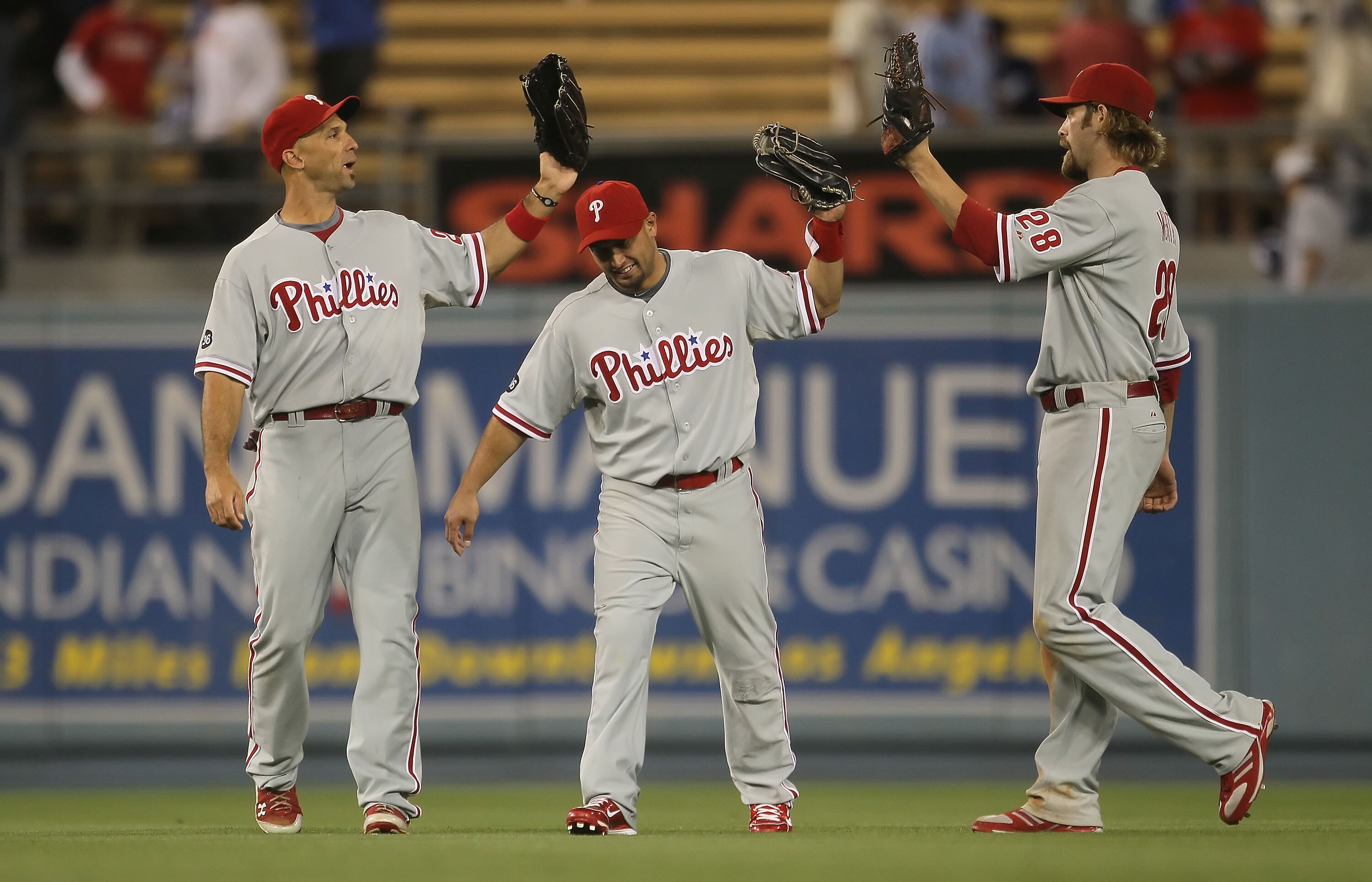 LOS ANGELES, CA - AUGUST 31:  (L-R) Raul Ibanez #29, Shane Victorino #8 and Jayson Werth #28 of the Philadelphia Phillies celebrate following their teams victory over the Los Angeles Dodgers at Dodger Stadium on August 31, 2010 in Los Angeles, California.
