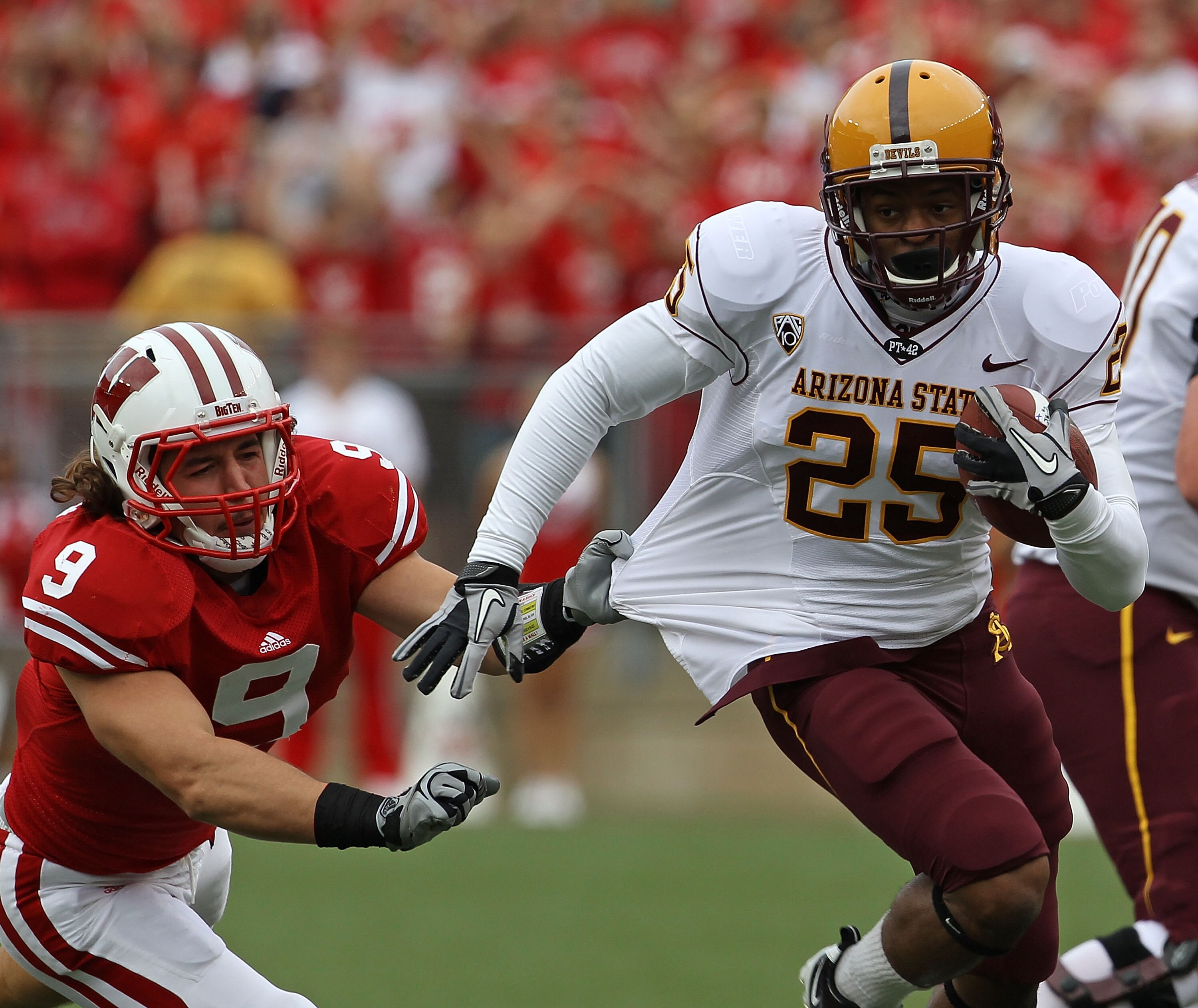 MADISON, WI - SEPTEMBER 18: Deantre Lewis #25 of the Arizona State Sun Devils tries to break away from Blake Sorensen #9 of the Wisconsin Badgers at Camp Randall Stadium on September 18, 2010 in Madison, Wisconsin. (Photo by Jonathan Daniel/Getty Images)
