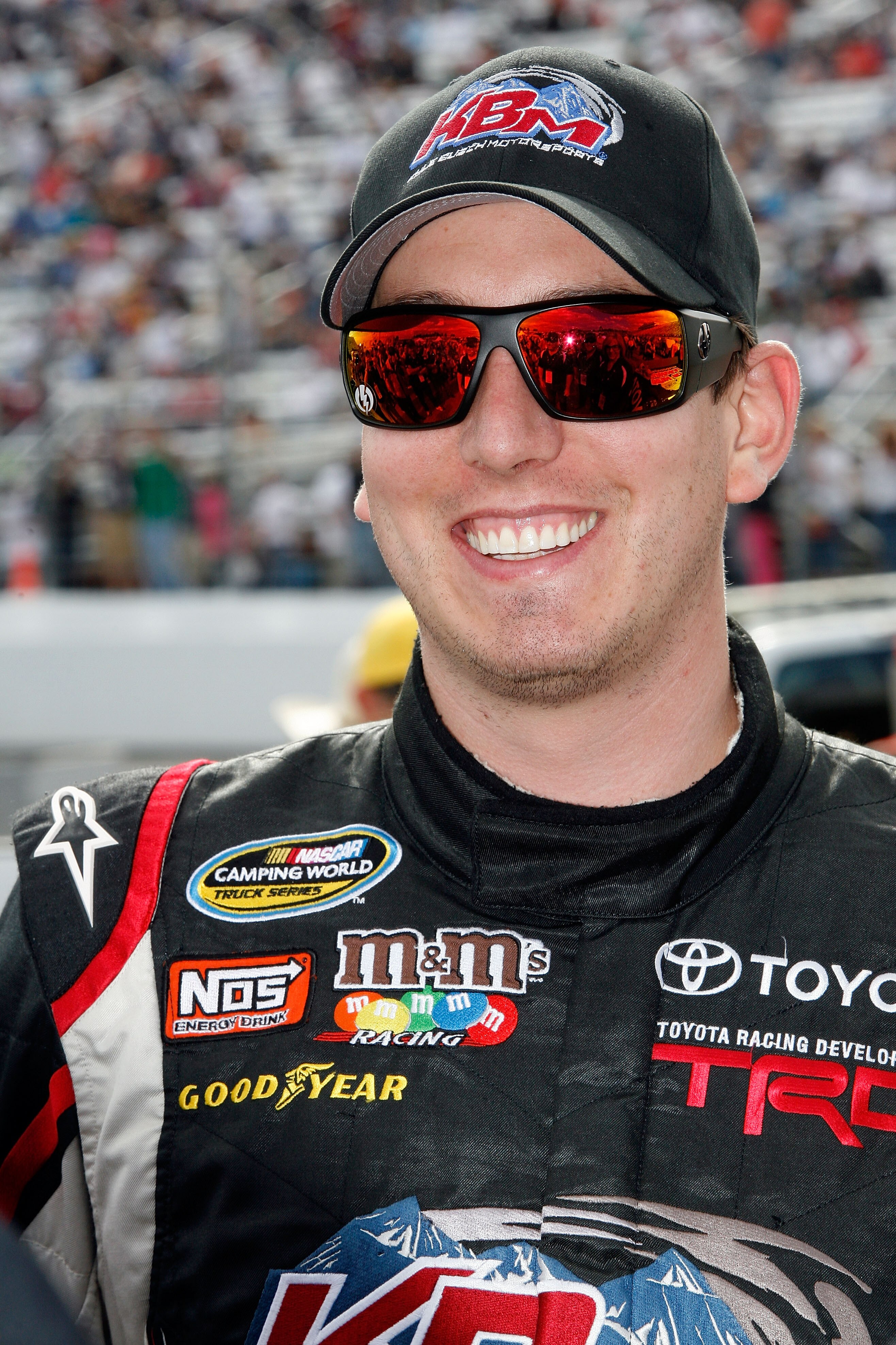 LOUDON, NH - SEPTEMBER 18:  Kyle Busch, driver of the #18 Toyota Tundra Toyota, smiles on the grid prior to the start of the NASCAR Camping World Truck Series TheRaceDayRaffleSeries.com 175 at the New Hampshire Motor Speedway on September 18, 2010 in Loud
