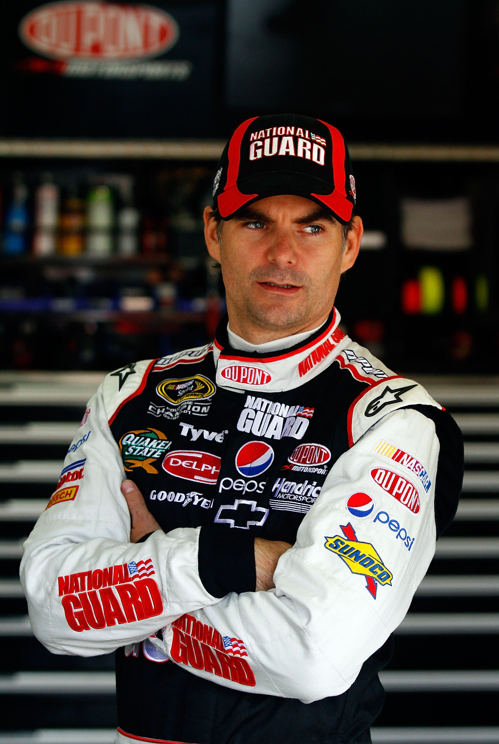 LOUDON, NH - SEPTEMBER 18:  Jeff Gordon, driver of the #24 DuPont / National Guard Facebook Chevrolet, looks on in the garage during practice for the NASCAR Sprint Cup Series Sylvania 300 at New Hampshire Motor Speedway on September 18, 2010 in Loudon, Ne