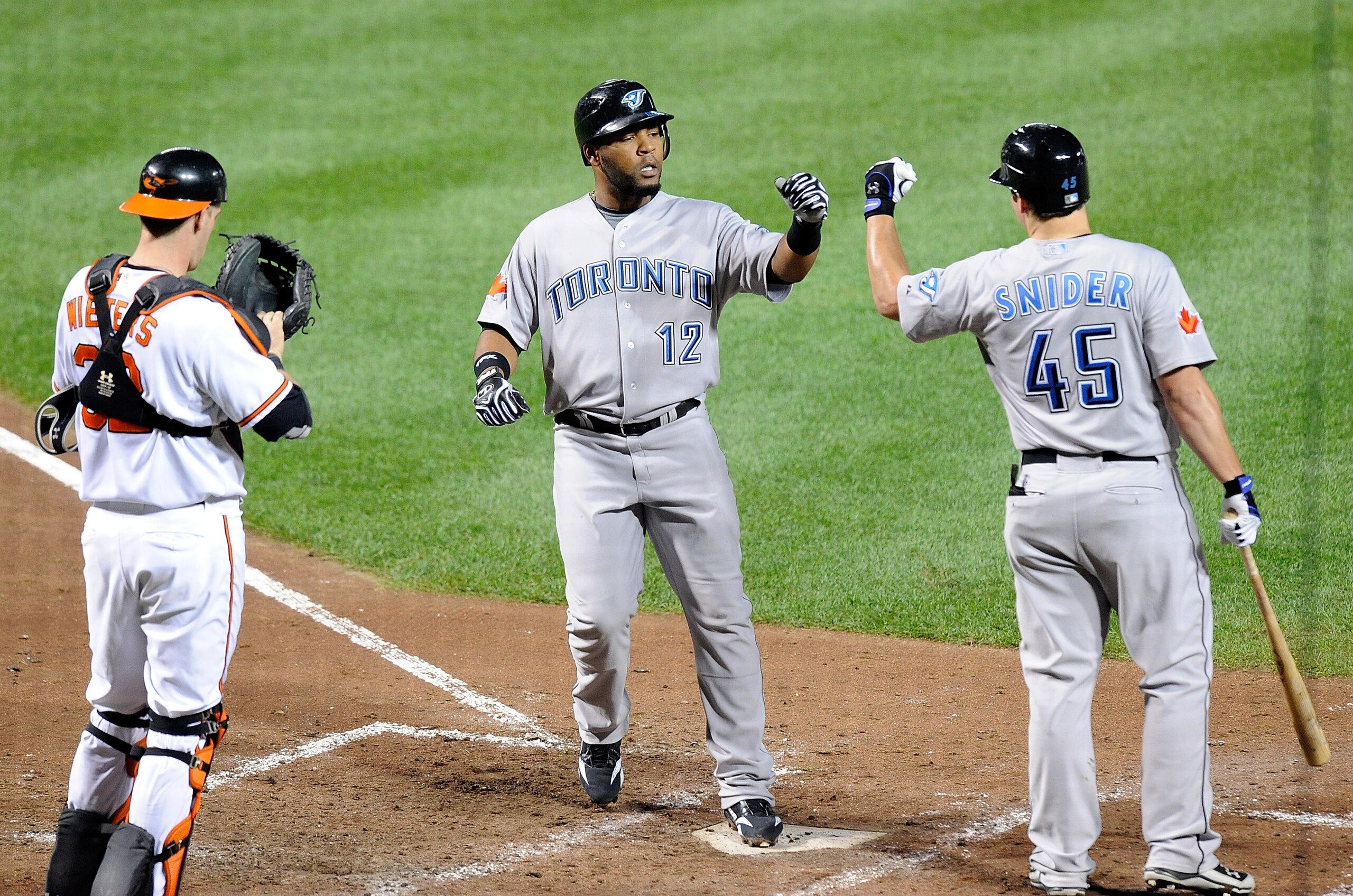 BALTIMORE - SEPTEMBER 13: Edwin Encarnacion #12 of the Toronto Blue Jays is congratulated by Travis Snider #45 after hitting a home run in the sixth inning against the Baltimore Orioles at Camden Yards on September 13, 2010 in Baltimore, Maryland. (Phot BALTIMORE - SEPTEMBER 13: Edwin Encarnacion #12 of the Toronto Blue Jays is congratulated by Travis Snider #45 after hitting a home run in the sixth inning against the Baltimore Orioles at Camden Yards on September 13, 2010 in Baltimore, Maryland. (Phot