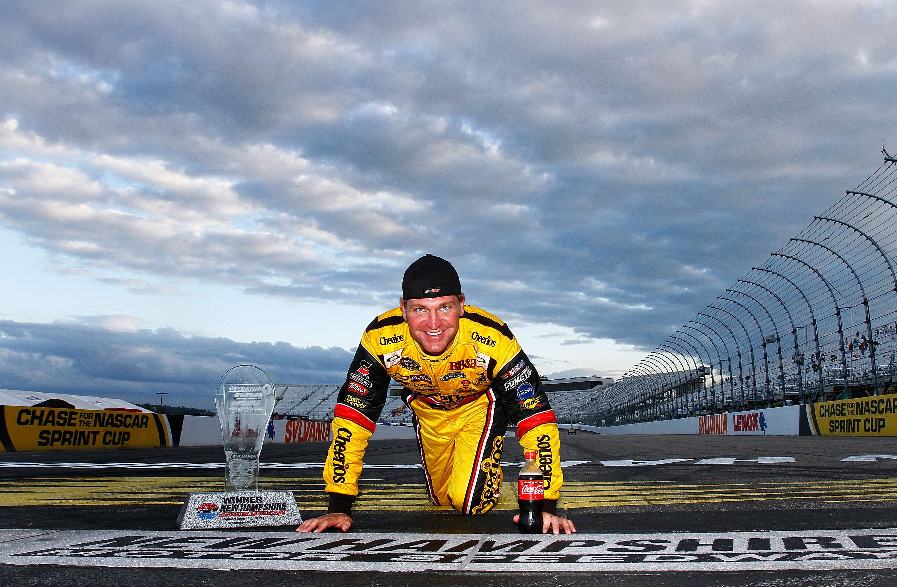LOUDON, NH - SEPTEMBER 19:  Clint Bowyer, driver of the #33 Cheerios / Hamburger Helper Chevrolet, poses at the start/finish line after he won the NASCAR Sprint Cup Series Sylvania 300 at New Hampshire Motor Speedway on September 19, 2010 in Loudon, New H