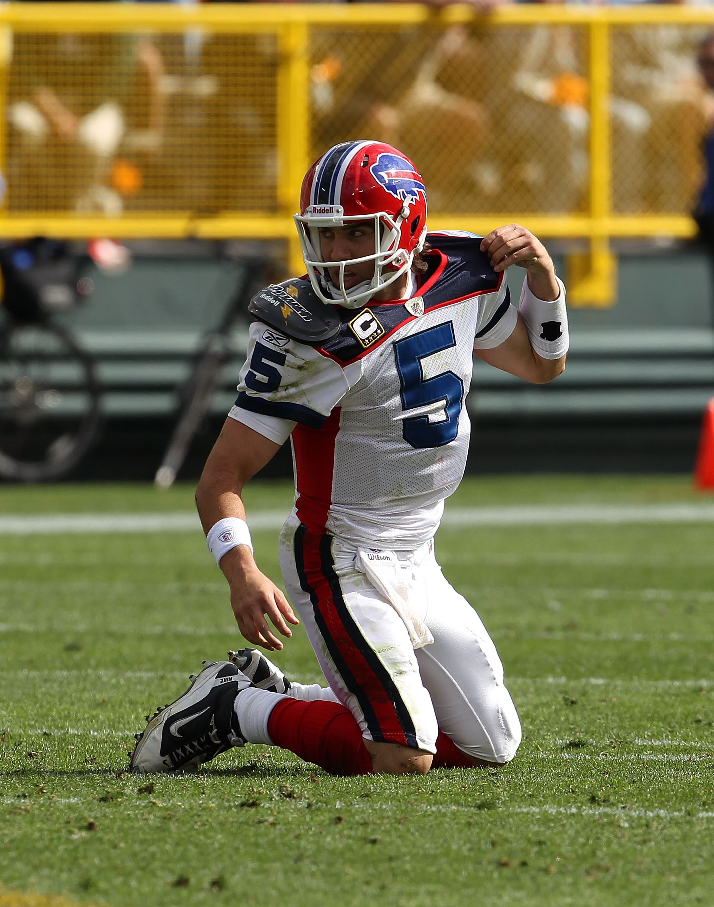 GREEN BAY, WI - SEPTEMBER 19: Trent Edwards #5 of the Buffalo Bills tries to adjust his shoulder pads after being knocked to the ground by a member of the Green Bay Packers defense at Lambeau Field on September 19, 2010 in Green Bay, Wisconsin. The Packer
