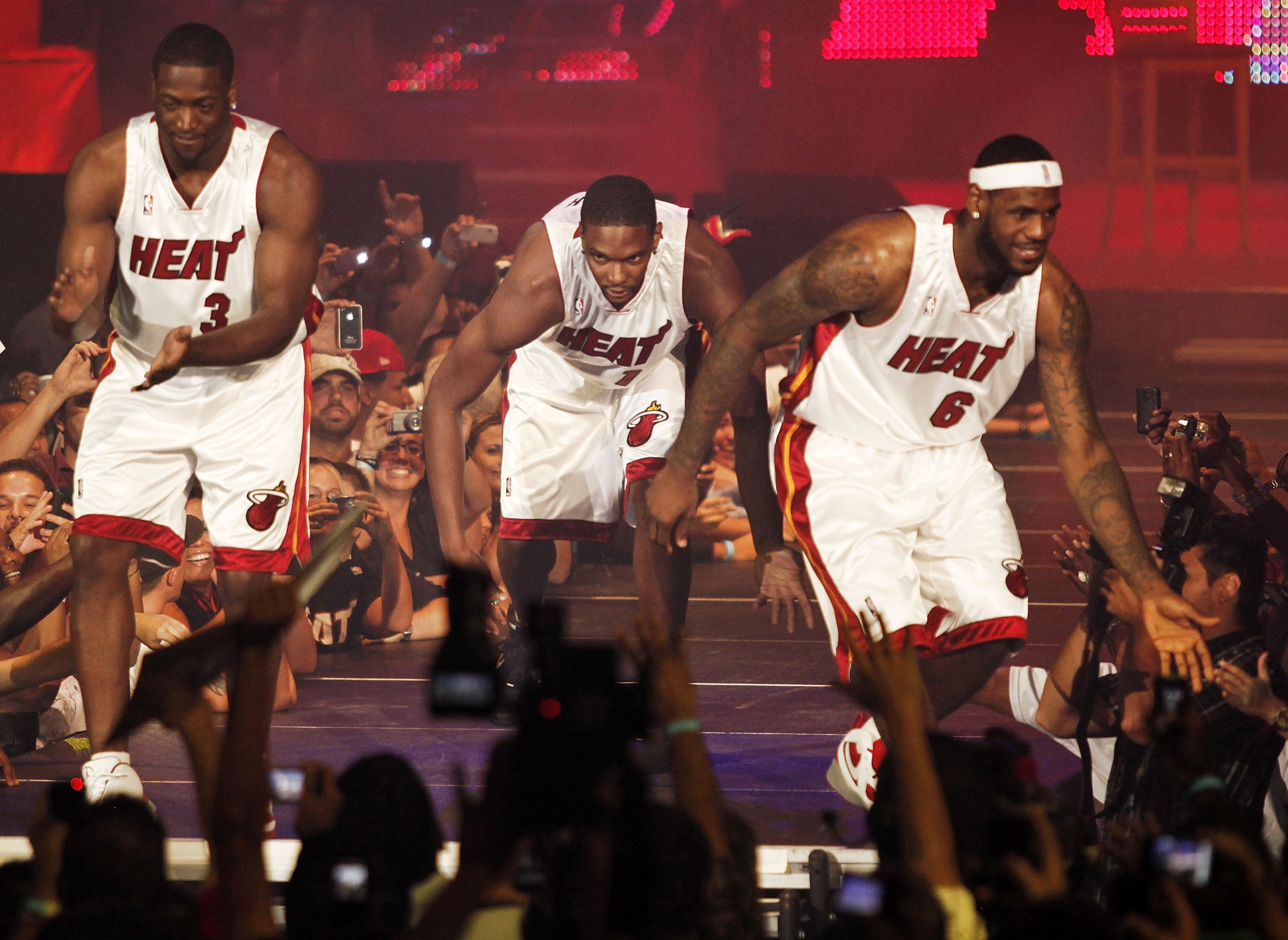 MIAMI - JULY 09:  Fans cheer as (L-R) Dwyane Wade #3, Chris Bosh #1 and LeBron James #6 of the Miami Heat are introduced during a welcome party at American Airlines Arena on July 9, 2010 in Miami, Florida.  (Photo by Marc Serota/Getty Images)