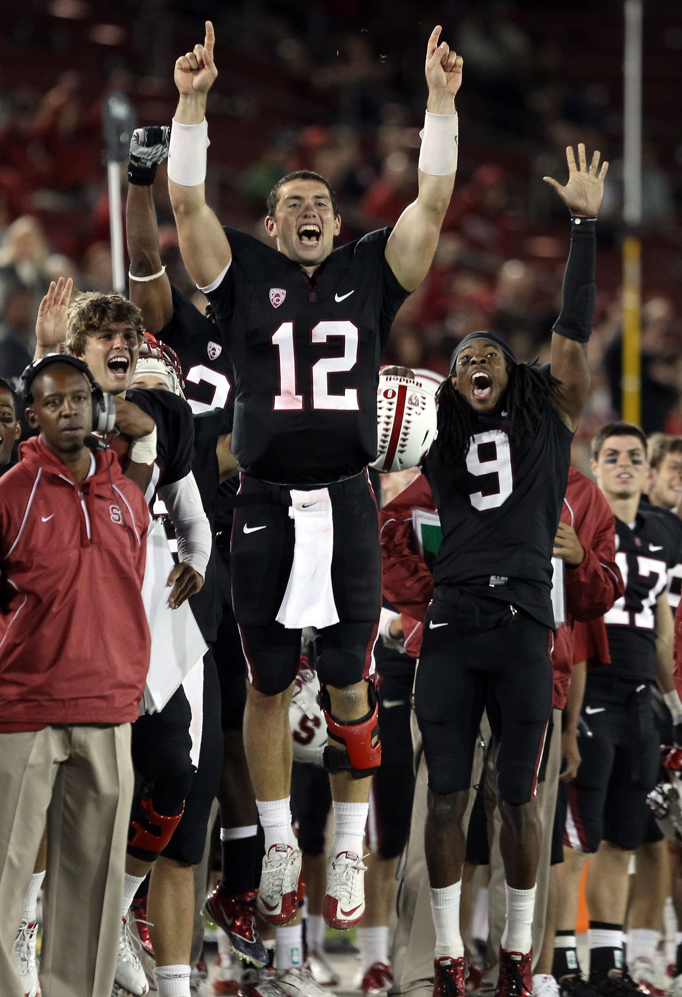 PALO ALTO, CA - SEPTEMBER 18:  Andrew Luck #12 and Richard Sherman #9 of the Stanford Cardinal celebrate from the sidelines after Stanford scored a touchdown to go up 67-24 in the fourth quarter of their game against the Wake Forest Demon Deacons at Stanf