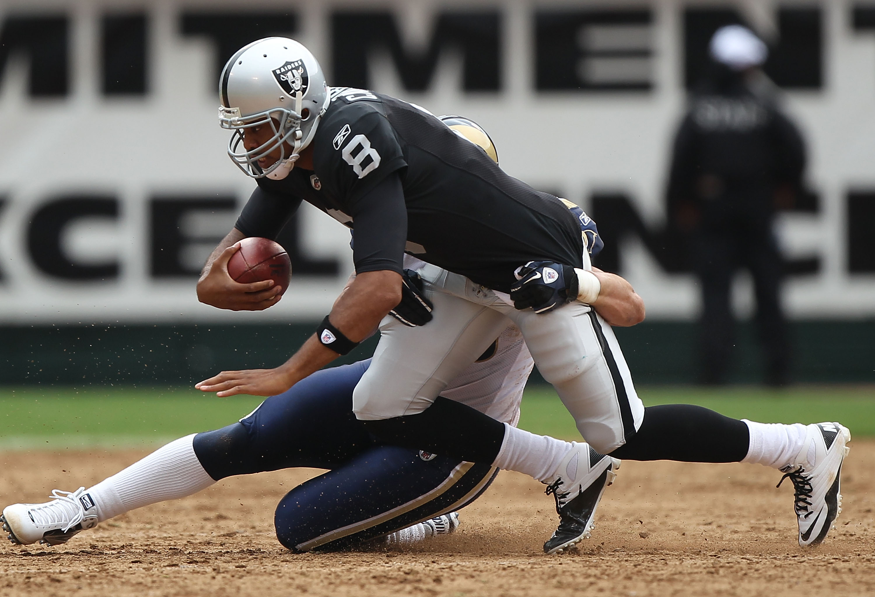 OAKLAND, CA - SEPTEMBER 19:  Jason Campbell #8 of the Oakland Raiders is sacked by James Laurinaitis #55 of the St. Louis Rams during an NFL game at Oakland-Alameda County Coliseum on September 19, 2010 in Oakland, California.  (Photo by Jed Jacobsohn/Get