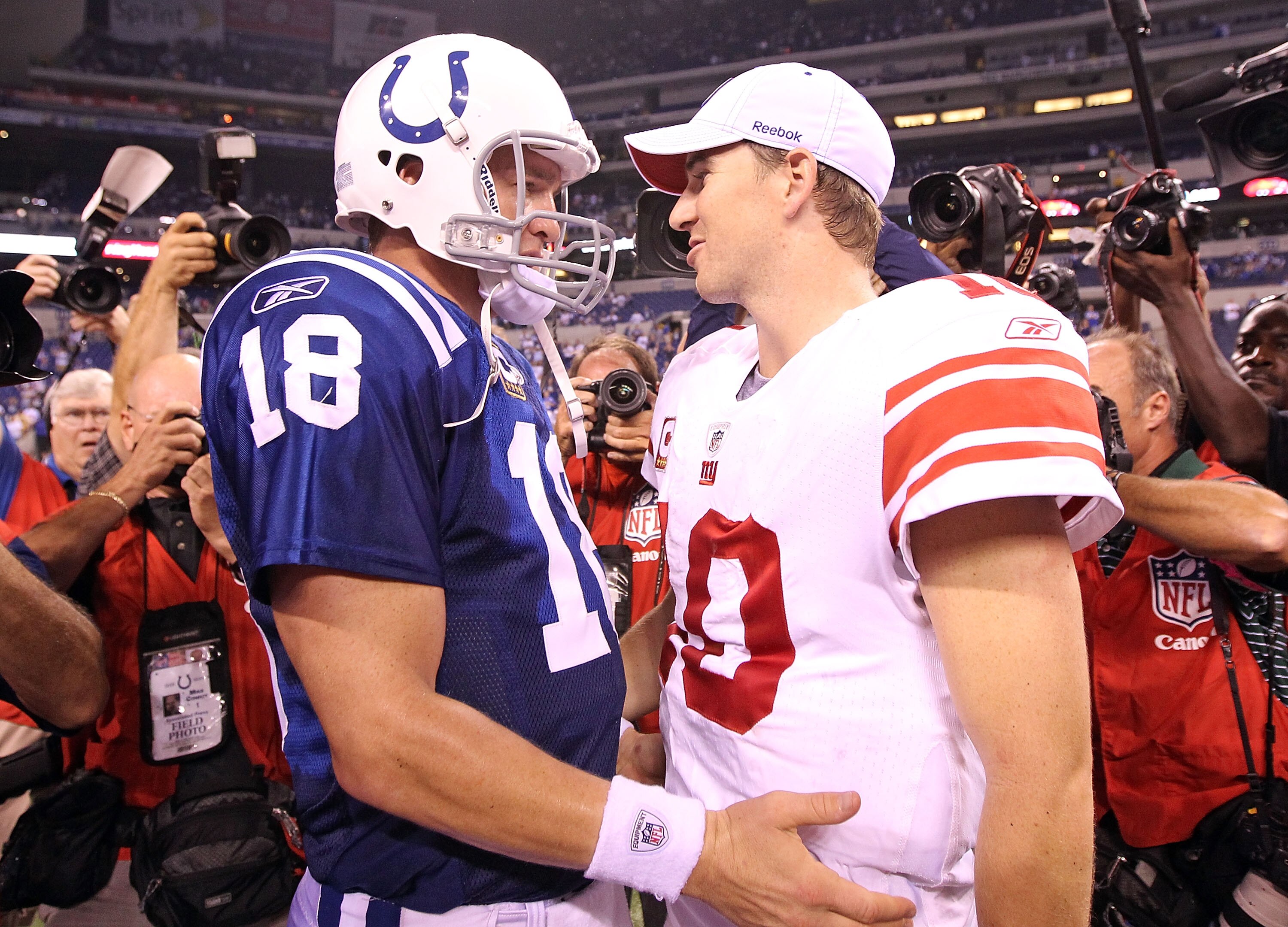 INDIANAPOLIS - SEPTEMBER 19:  Eli Manning #10 of the New York Giants and Peyton Manning #18 of the Indianapolis Colts embrace following the Colts 38-14 win at Lucas Oil Stadium on September 19, 2010 in Indianapolis, Indiana.  (Photo by Andy Lyons/Getty Im
