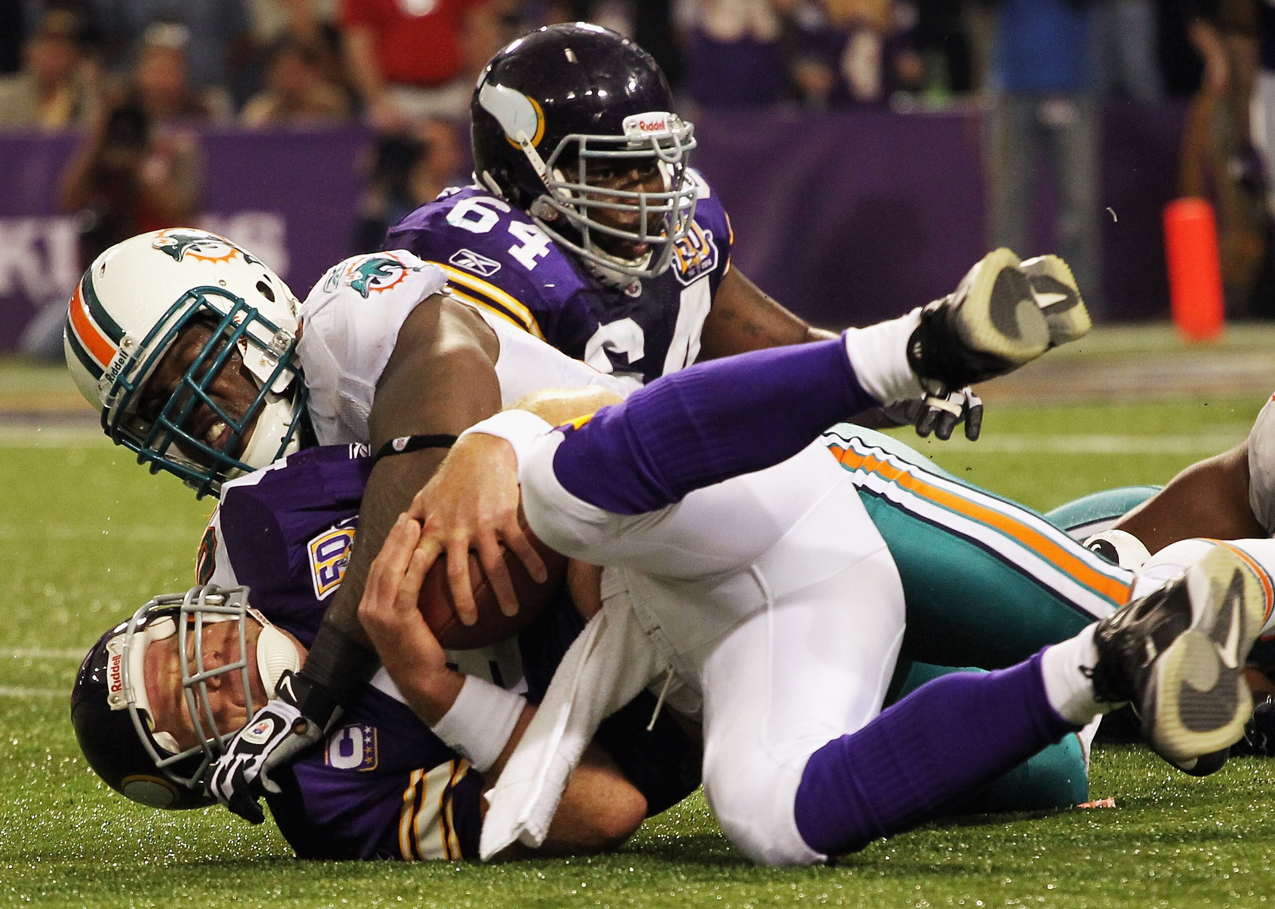 MINNEAPOLIS - SEPTEMBER 19:  Quarterback Brett Favre #4 of the Minnesota Vikings is sacked by Kendall Langford #70 of the Miami Dolphins during the second half of the game on September 19, 2010 at Hubert H. Humphrey Metrodome in Minneapolis, Minnesota.  (