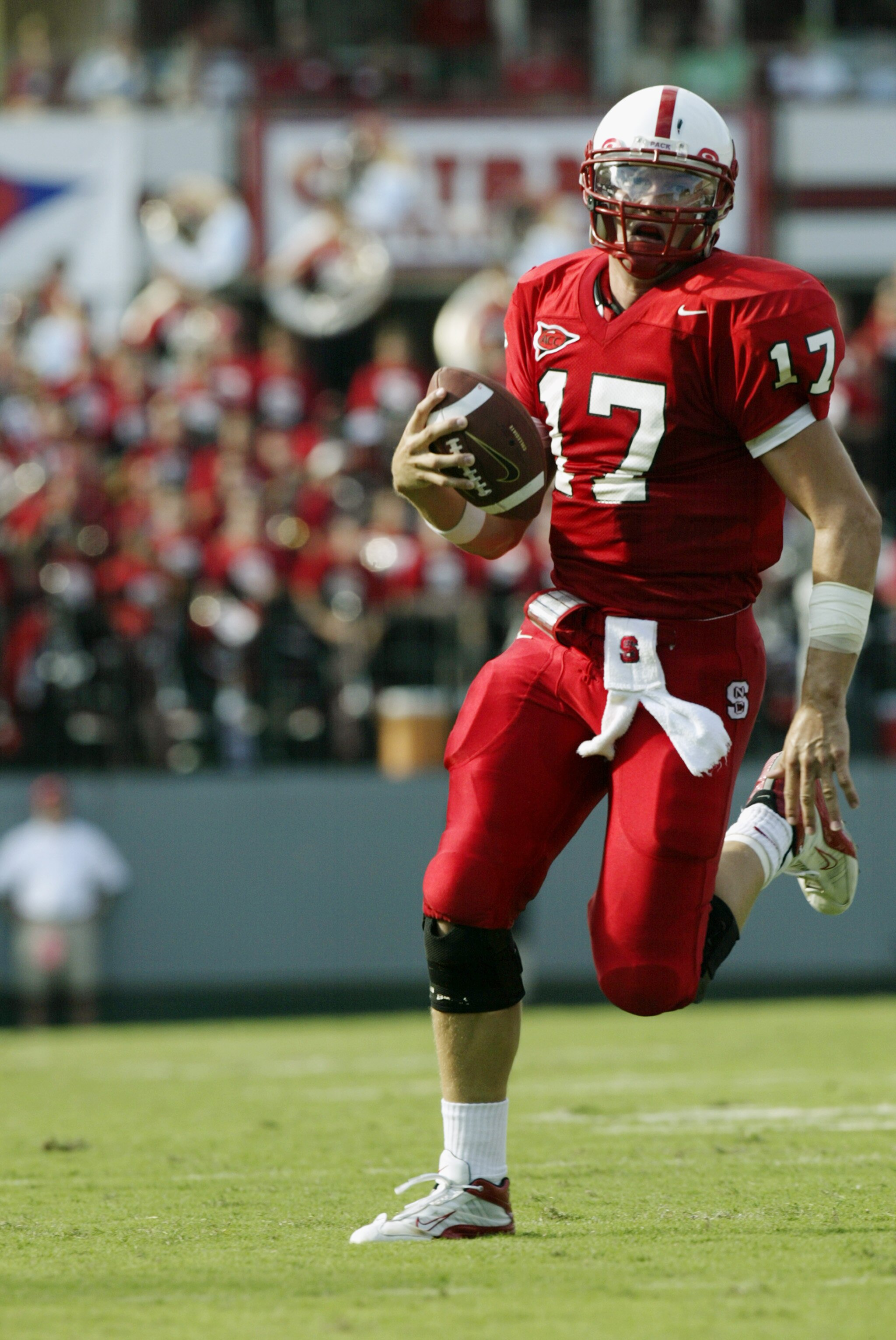 RALEIGH, NC - SEPTEMBER 27:  Quarterback Philip Rivers #17 of the North Carolina State University Wolfpack scrambles with the ball against the University of North Carolina Tar Heels during the game at Carter Finley Stadium on September 27, 2003 in Raleigh