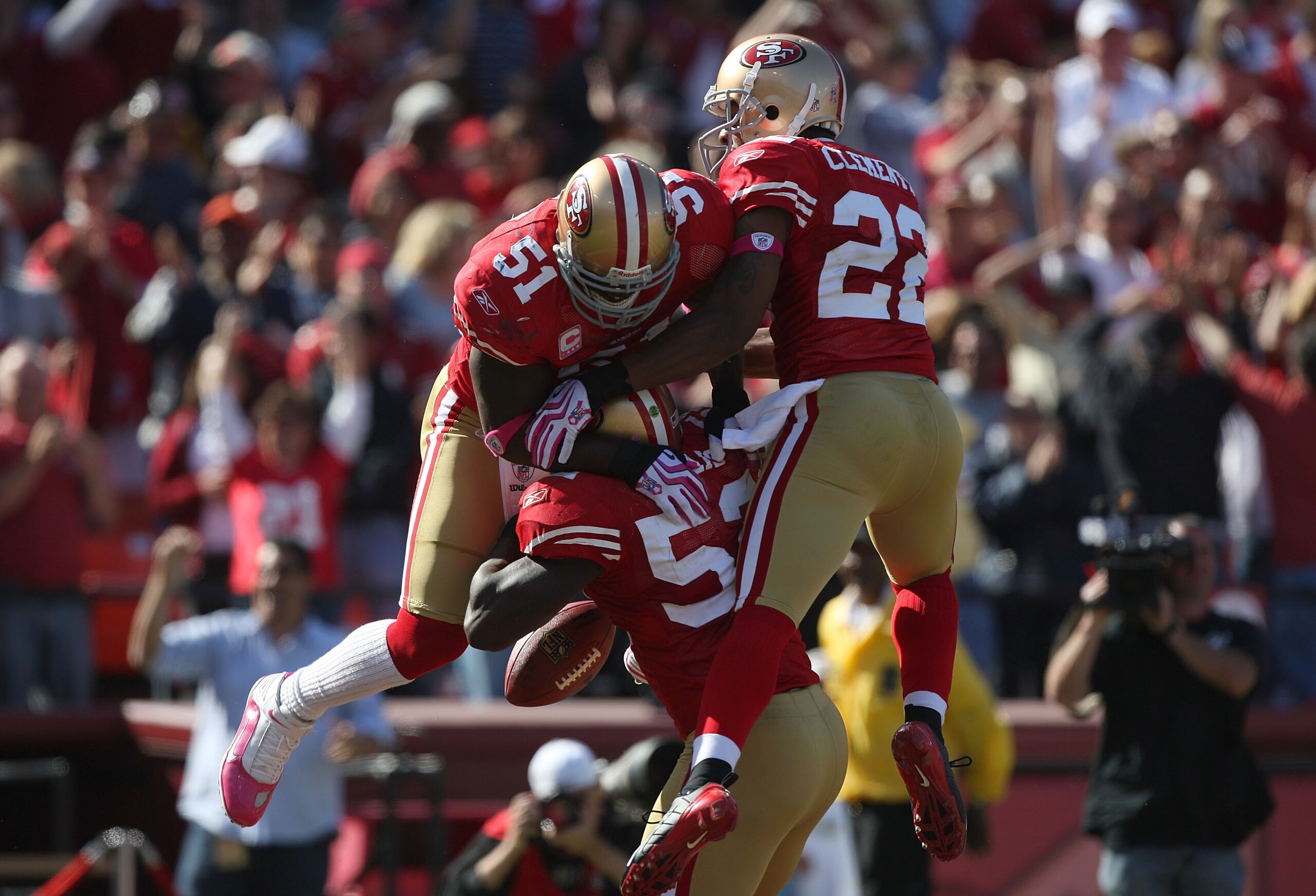 SAN FRANCISCO - OCTOBER 04:  Patrick Willis #52 of the San Francisco 49ers celebrates with Takeo Spikes #51 and Nate Clements #22 after returning an interception for a touchdown against the St. Louis Rams during an NFL game on October 4, 2009 at Candlesti