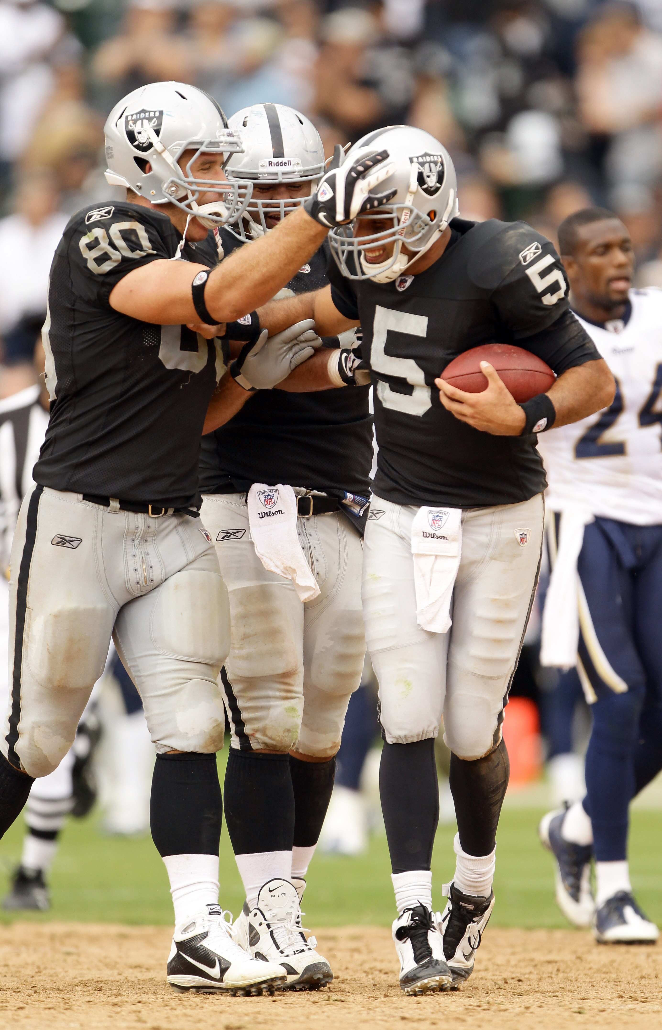OAKLAND, CA - SEPTEMBER 19:  Bruce Gradkowski #5 of the Oakland Raiders is congratulated by Zach Miller #80 after they beat the St. Louis Rams at the Oakland-Alameda County Coliseum on September 19, 2010 in Oakland, California.  (Photo by Ezra Shaw/Getty