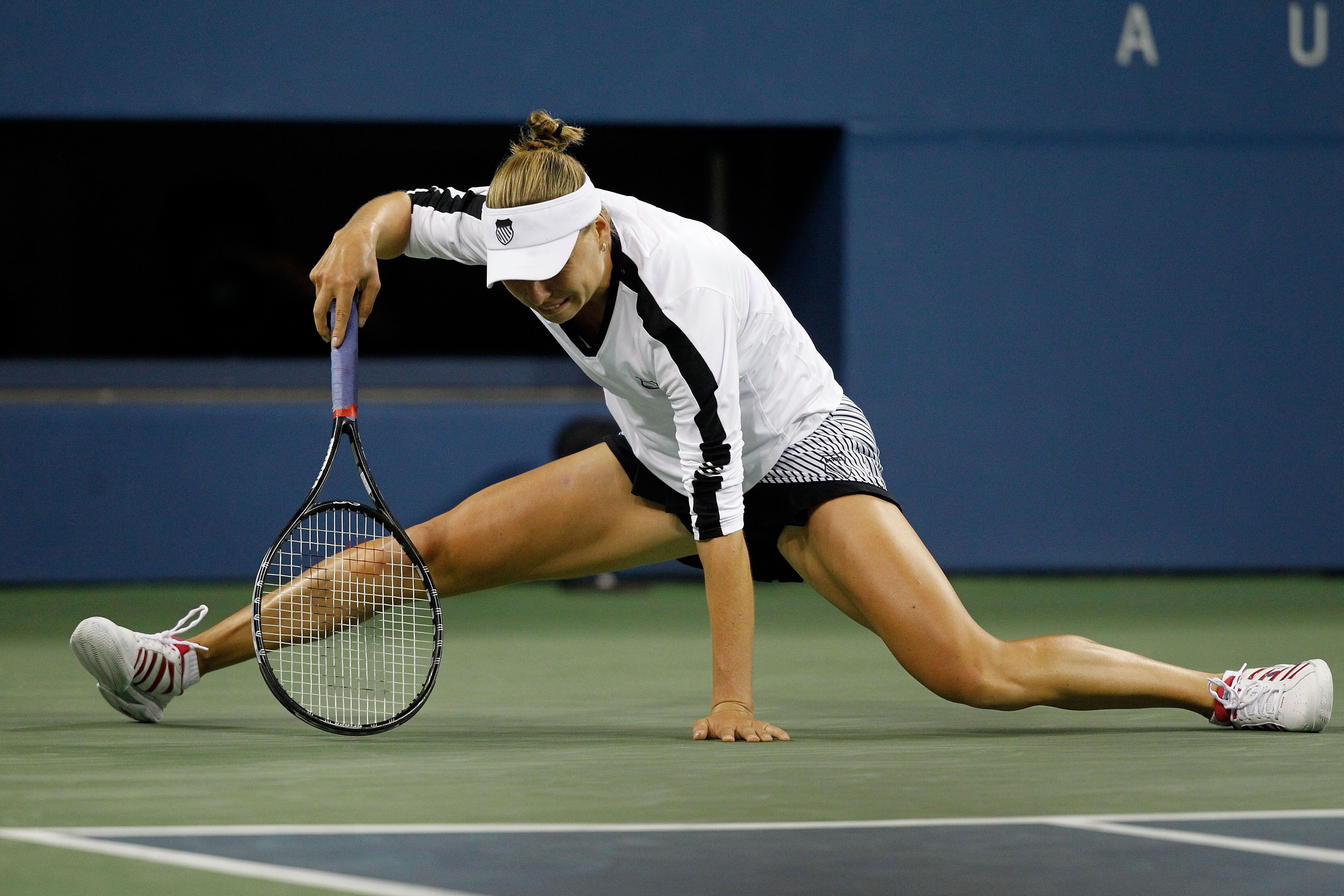 NEW YORK - SEPTEMBER 06:  Vera Zvonareva of Russia picks herself up after she stretched for a return shot against Andrea Petkovic of Germany during day eight of the 2010 U.S. Open at the USTA Billie Jean King National Tennis Center on September 6, 2010 in