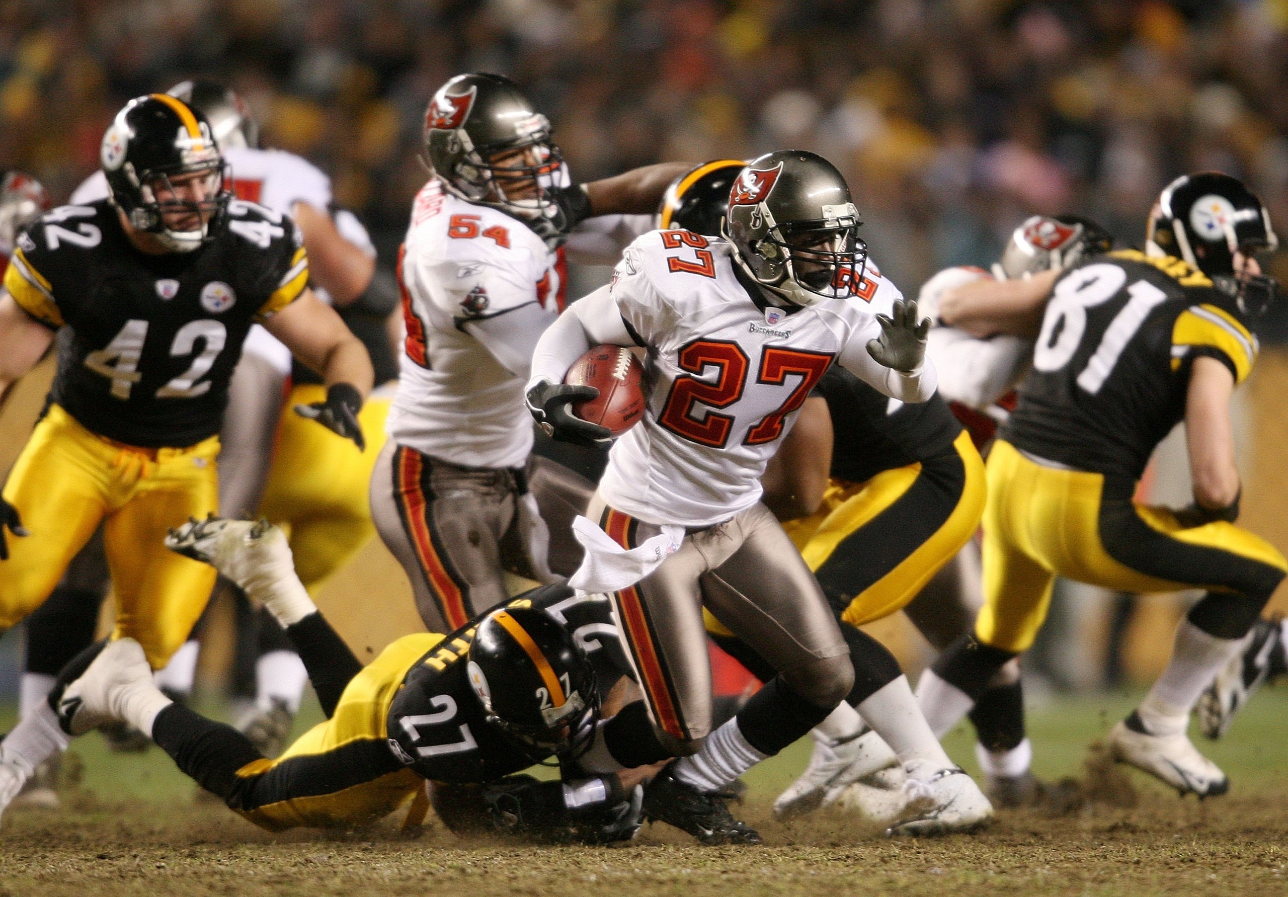 PITTSBURGH - DECEMBER 3:   Torrie Cox #27 of the Tampa Bay Buccaneers is tackled by Anthony Smith #27 of the Pittsburgh Steelers at Heinz Field on December 3, 2006 in Pittsburgh, Pennsylvania.  (Photo by Nick Laham/Getty Images)