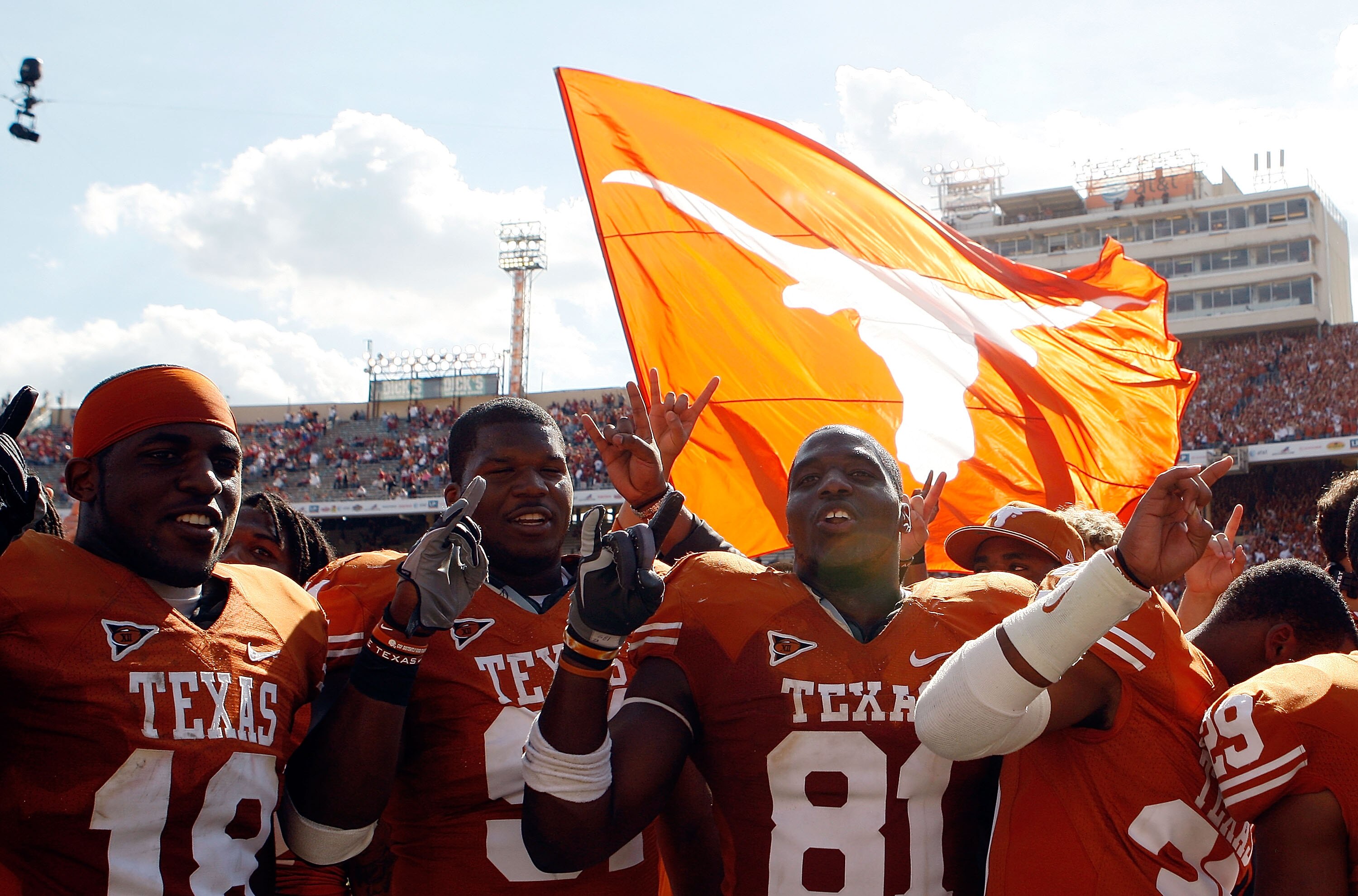 DALLAS - OCTOBER 17:  (L-R) Emmanuel Acho #18, Kheeston Randall #91 and Sam Acho #81 of the Texas Longhorns celebrate a win against the Oklahoma Sooners at Cotton Bowl on October 17, 2009 in Dallas, Texas.  (Photo by Ronald Martinez/Getty Images)